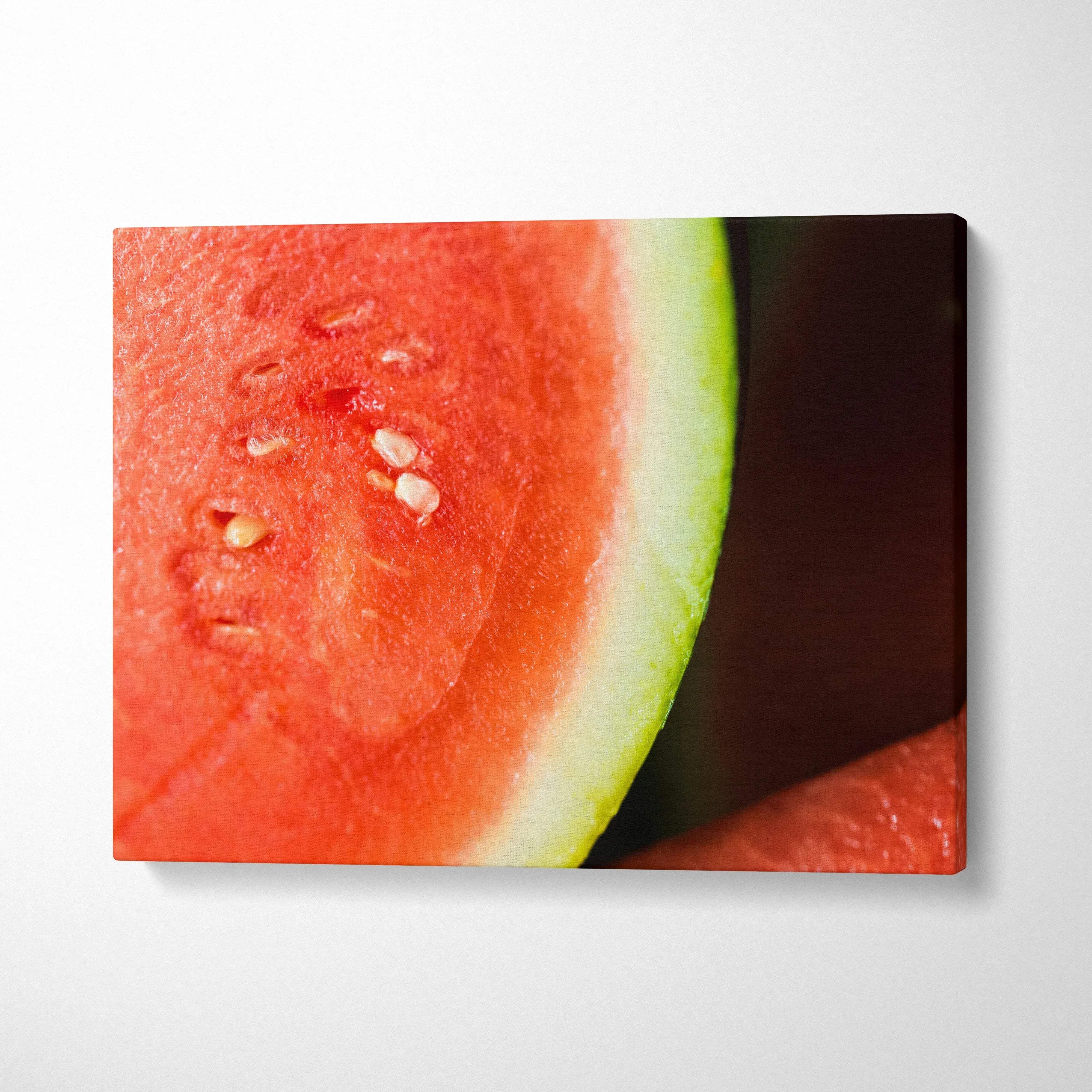 Vibrant watermelon close-up on canvas wall art with bright red, green, and black seeds for colorful decor.