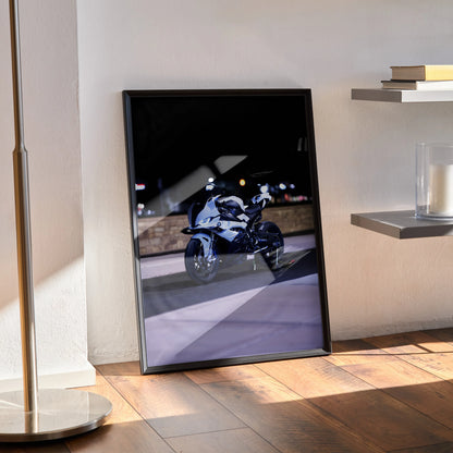 BMW S1000RR motorcycle poster in black frame leaning against wall, modern wall art.