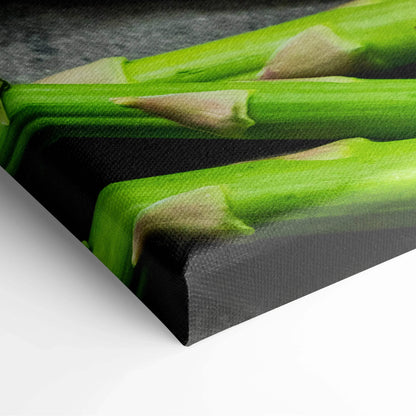 Close-up of vibrant canvas wall art featuring green asparagus spears on textured fabric for kitchen decor.