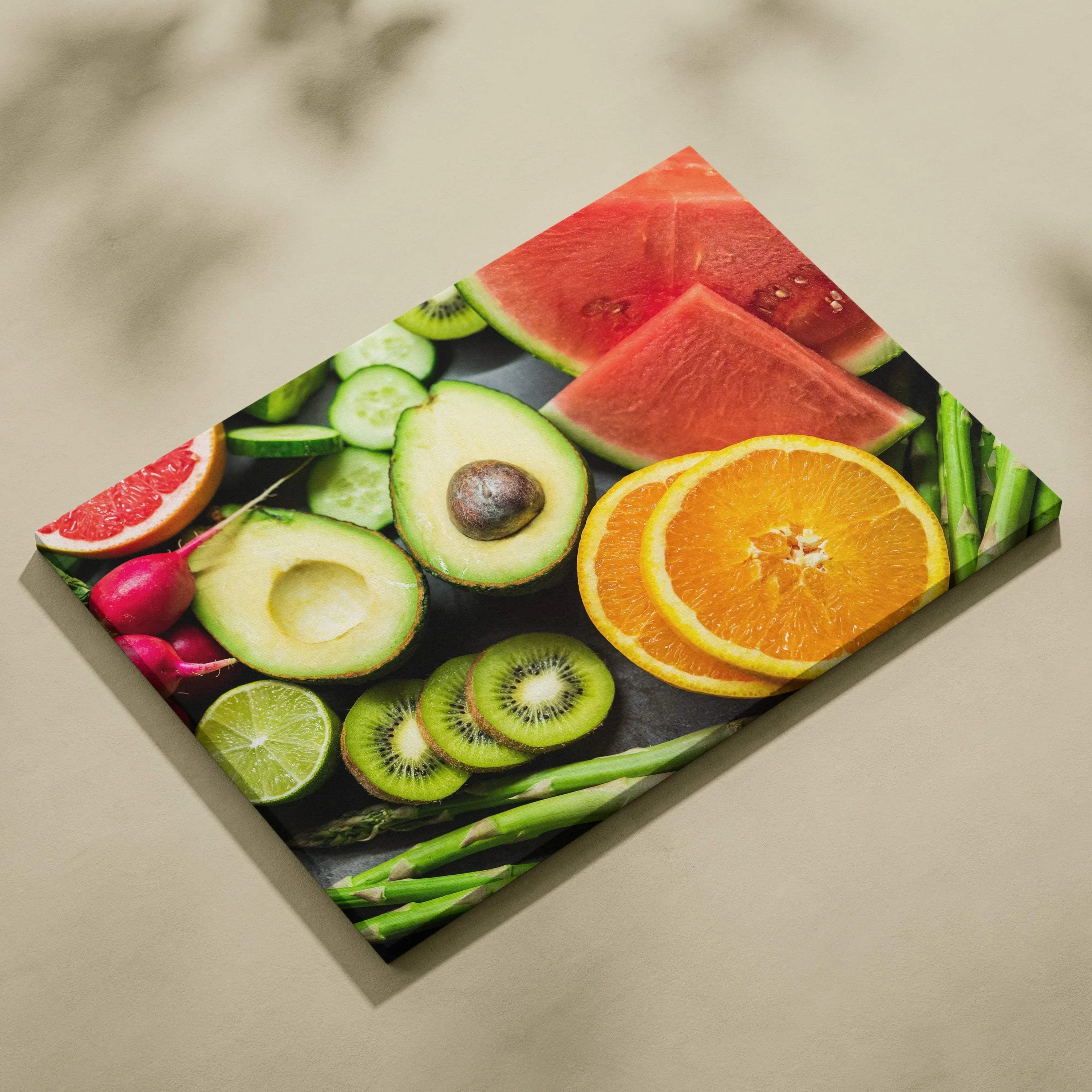 Colorful canvas wall art featuring fresh fruit slices including oranges, watermelon, kiwi, avocado, lime, and radishes on a.