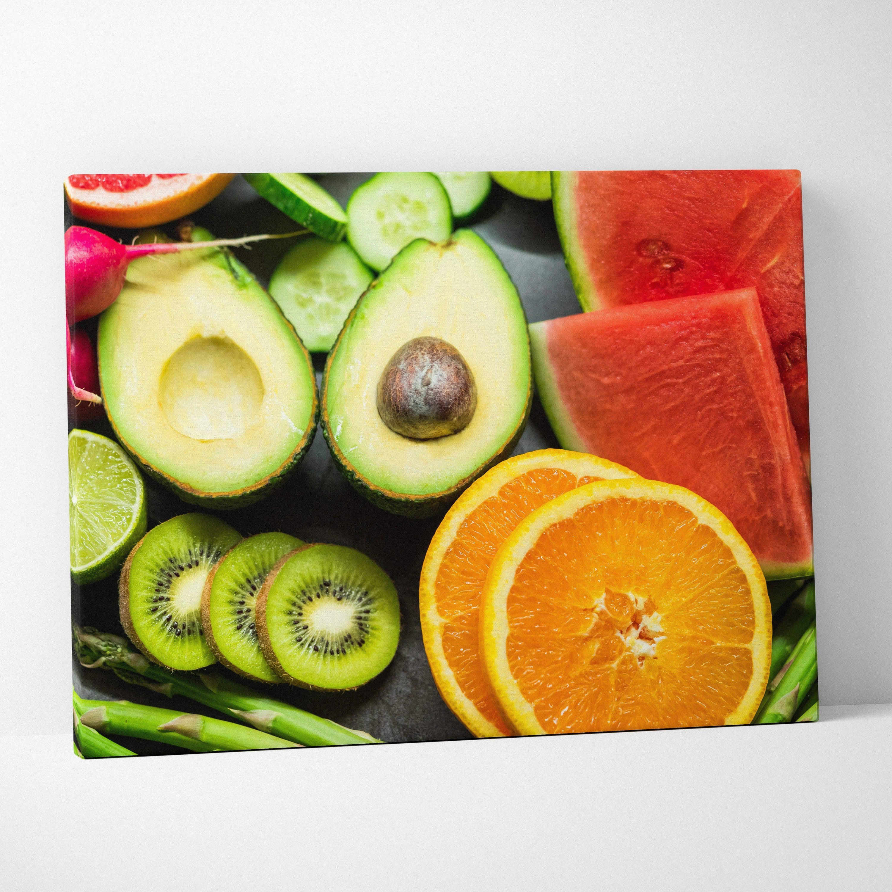 Colorful canvas wall art featuring vibrant sliced oranges, avocado, kiwi, watermelon, and lime on a dark background for home