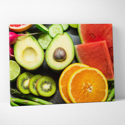 Colorful canvas wall art featuring vibrant sliced oranges, avocado, kiwi, watermelon, and lime on a dark background for home