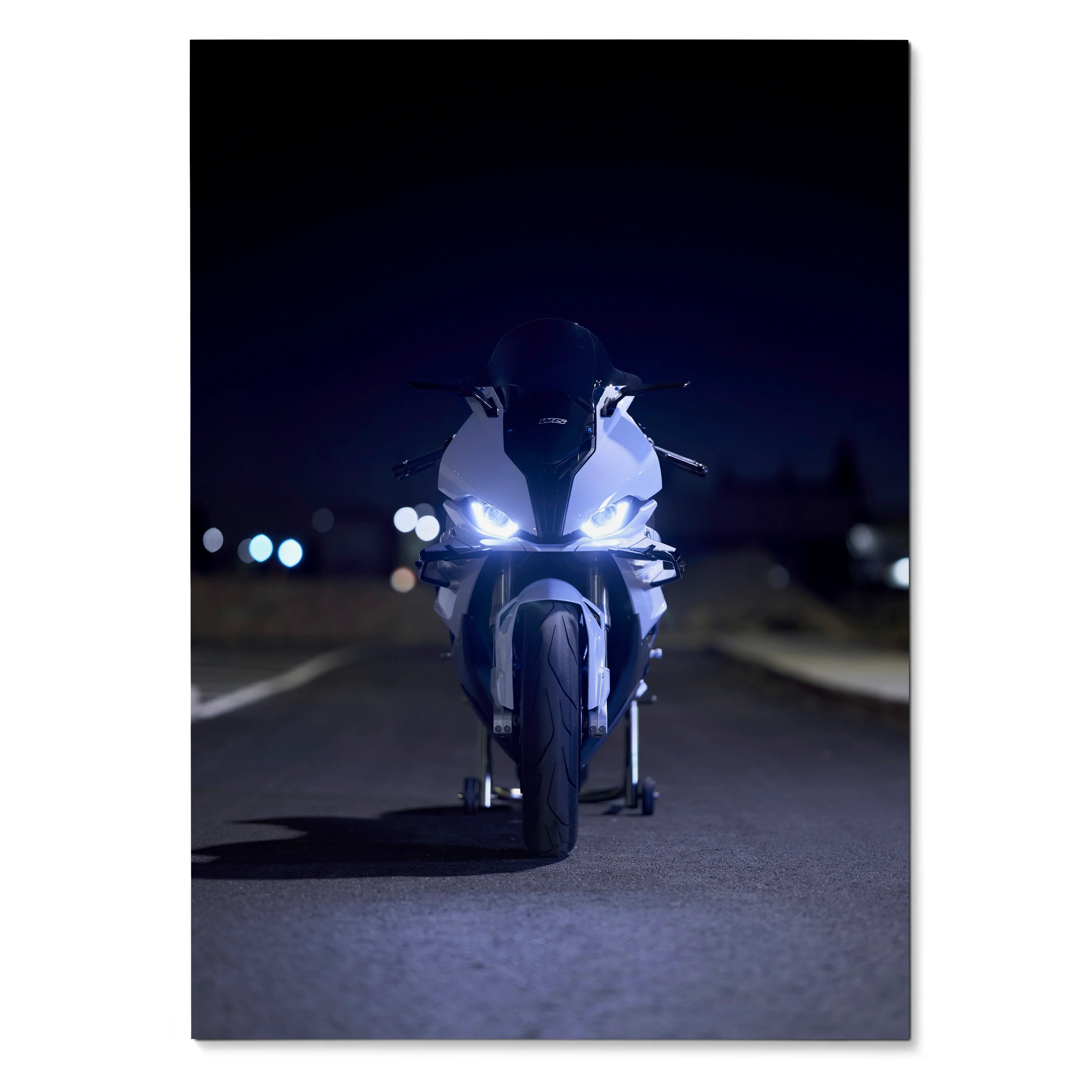 BMW S1000RR motorcycle illuminated at night poster wall art with dark background.