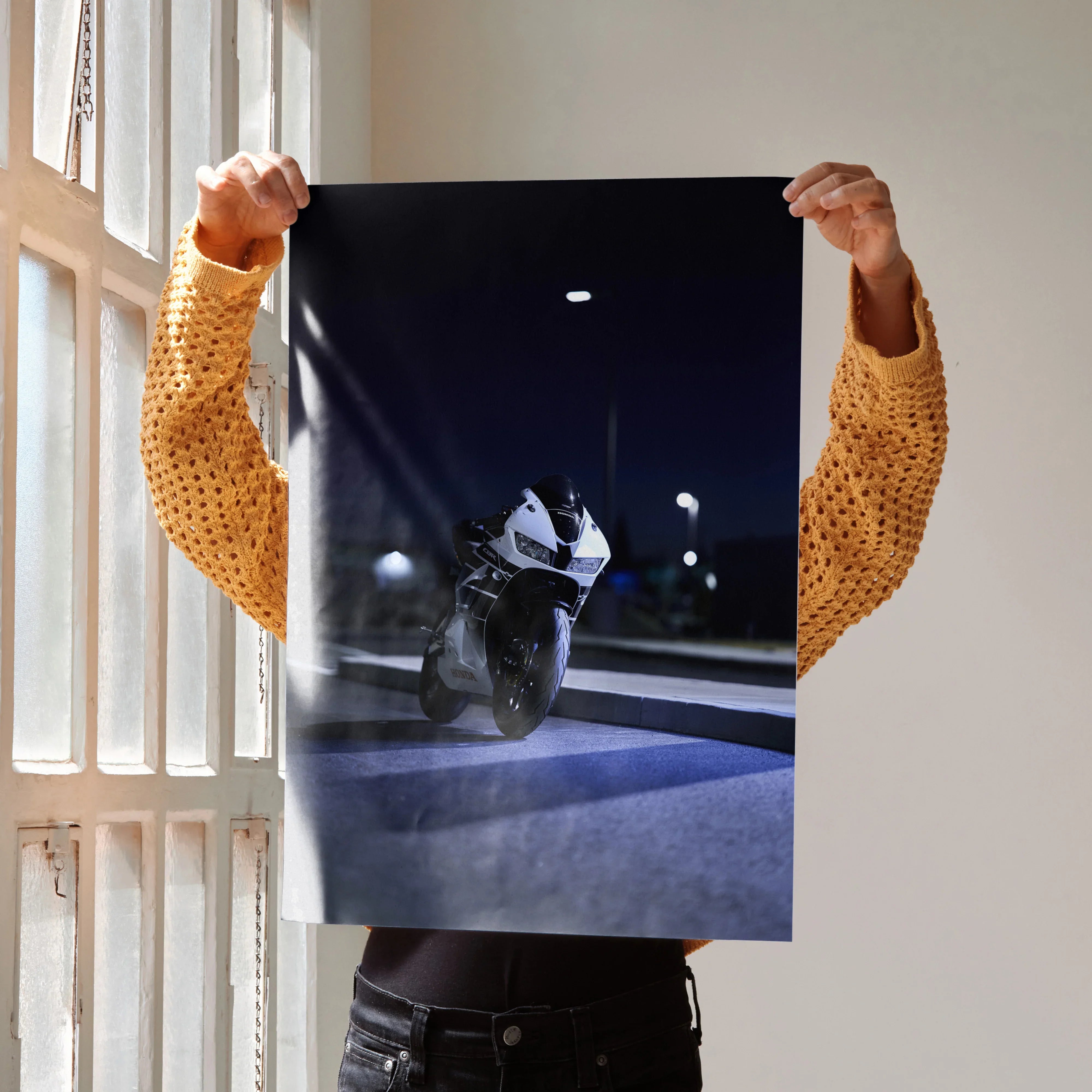 Honda CBR600RR motorcycle at night poster held up as wall art with dark city background.