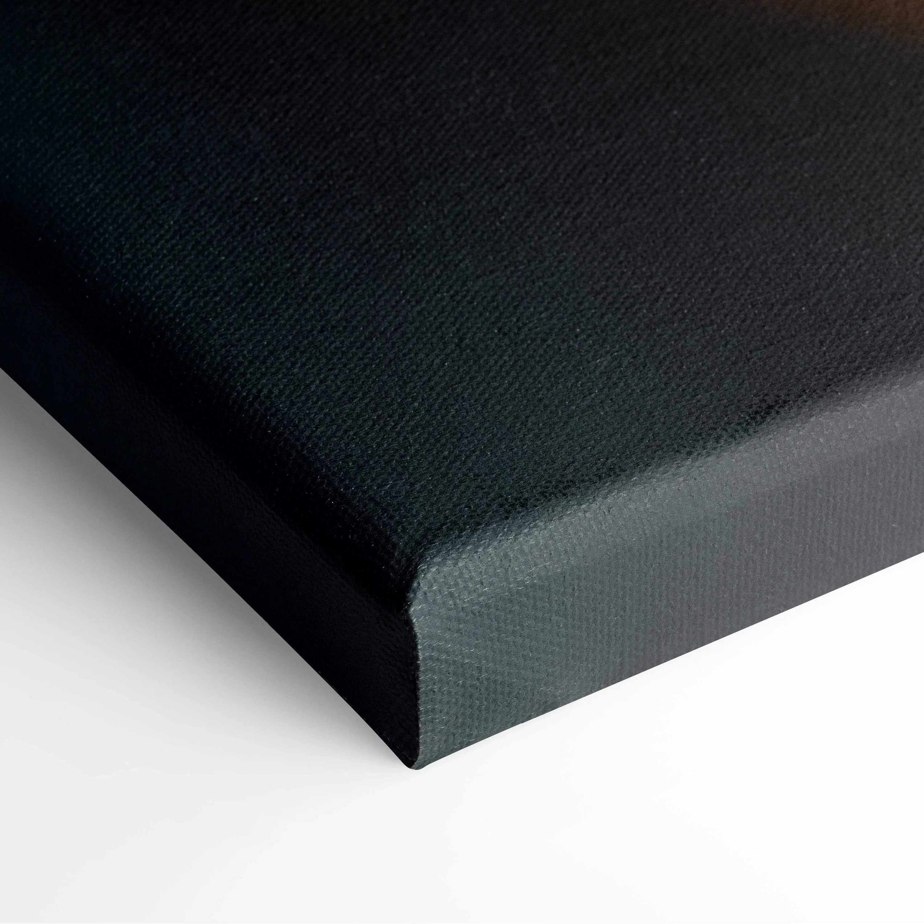 Close-up of black wrapped canvas edge with textured surface for wall art decor.