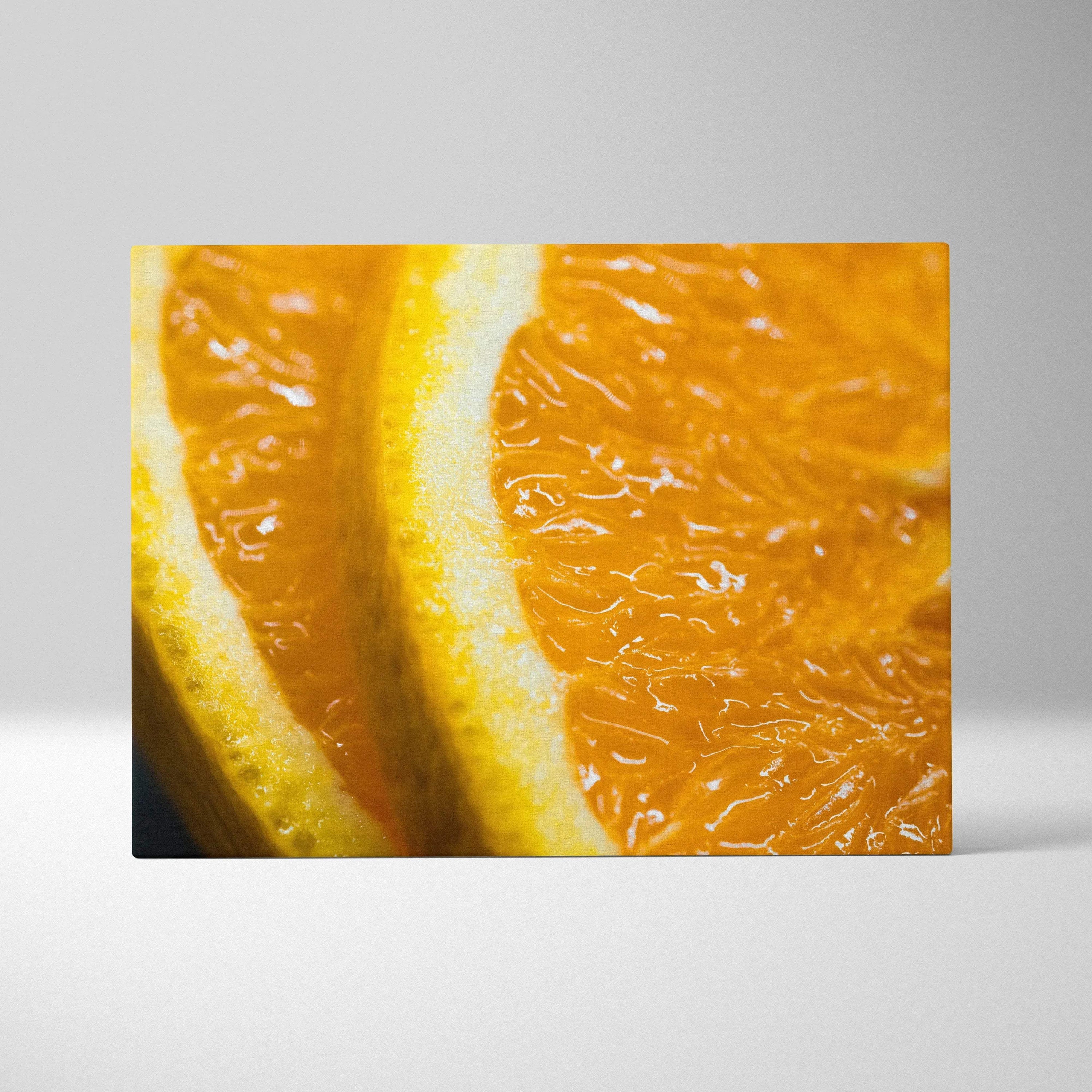 Close-up canvas wall art print featuring vibrant orange slices with textured juicy pulp and bright yellow rind.