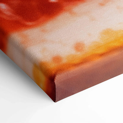 Close-up of textured canvas print with vibrant orange and red grapefruit design on stretched wooden frame.