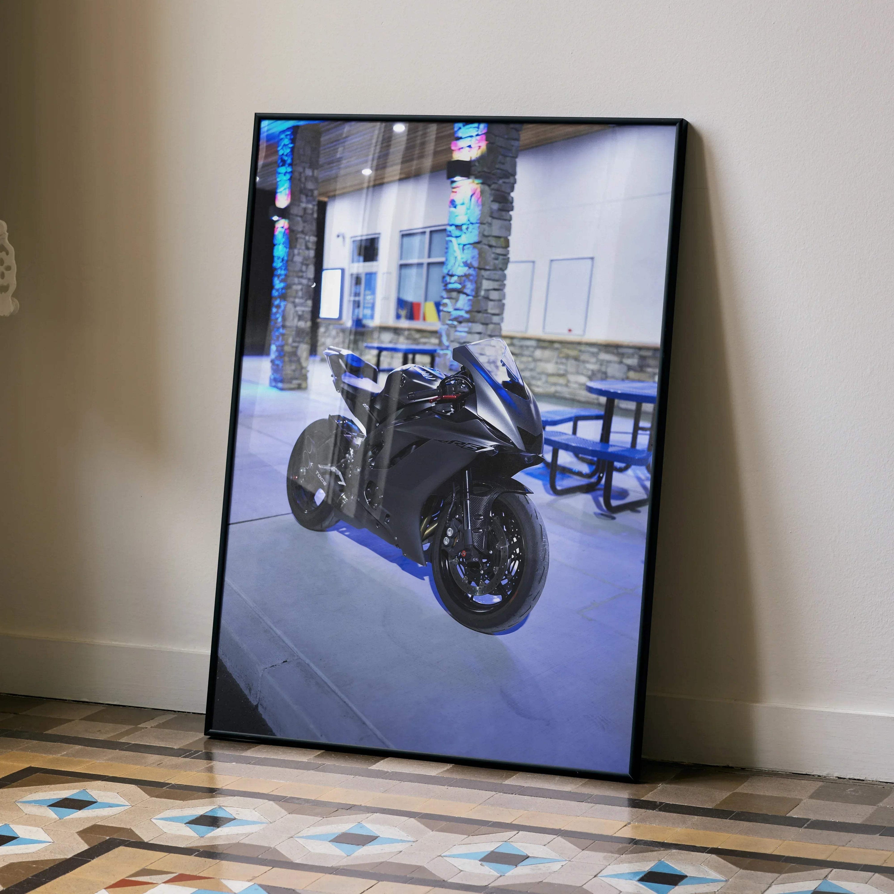 Framed Yamaha R6 motorcycle poster leaning against wall in modern interior wall art.