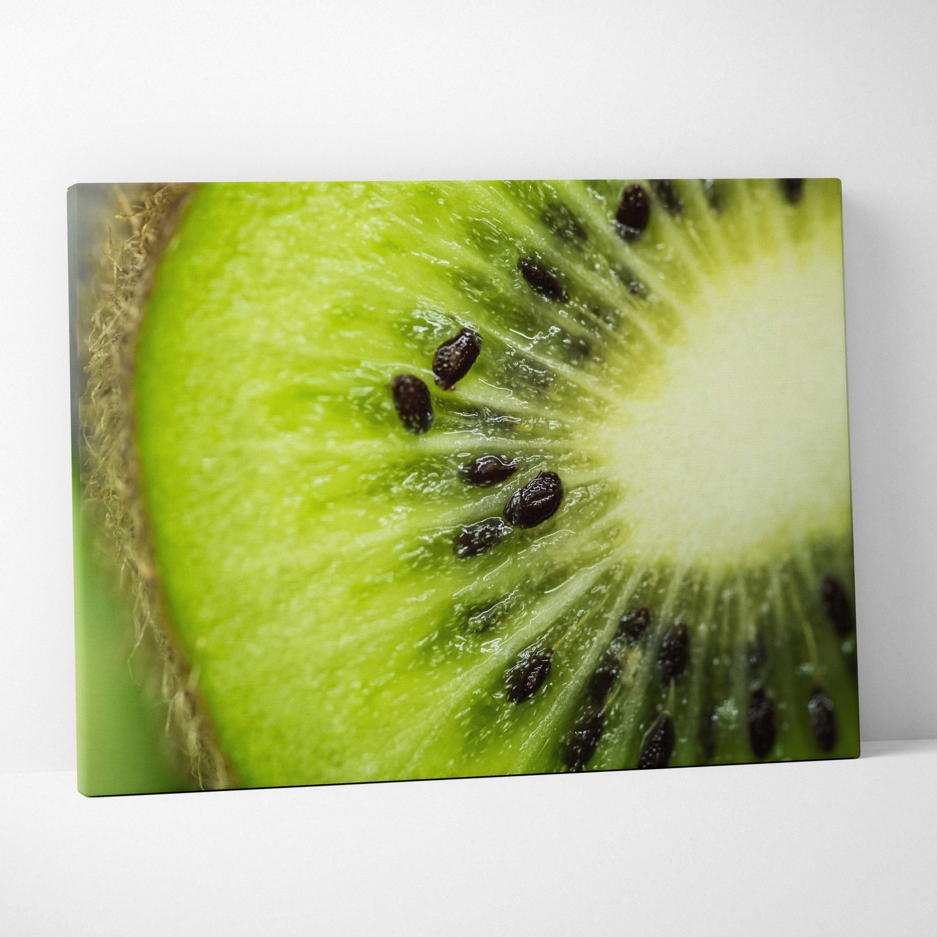Close-up high-resolution canvas wall art of a vibrant green kiwi slice with visible black seeds and textured skin edge.