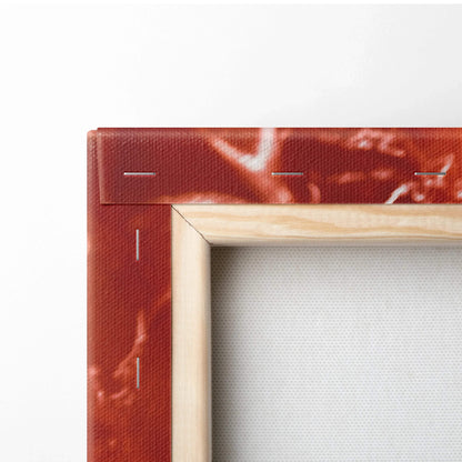 Close-up of red and white grapefruit-themed canvas wall art with natural wooden frame edge and visible canvas texture.