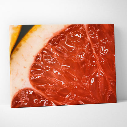 Close-up canvas wall art featuring vibrant, juicy red grapefruit slices with rich texture and glossy details.