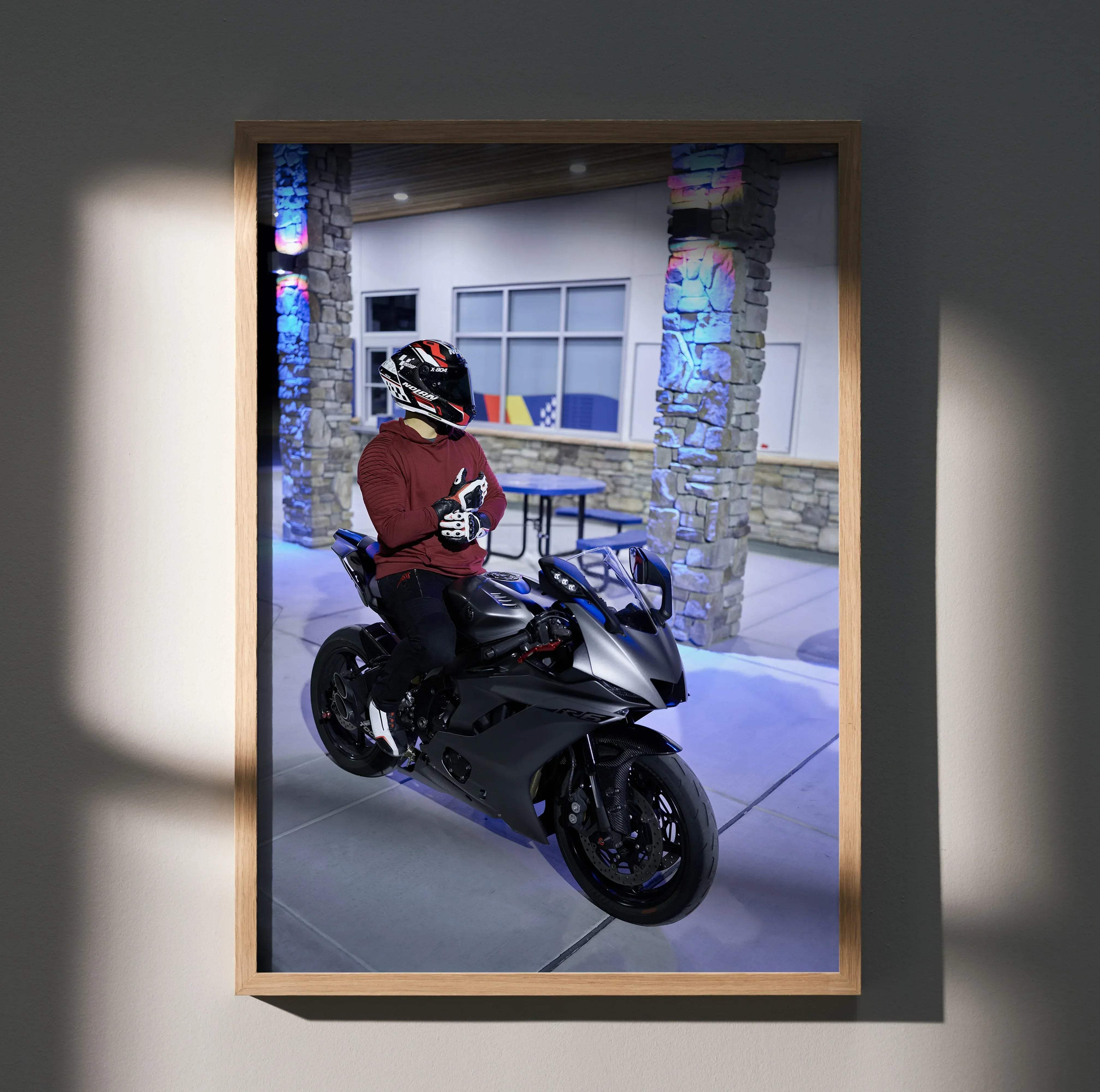 Black and silver sport motorcycle with sleek aerodynamic design framed in light wood featuring nolan x804 helmet and yamaha r6
