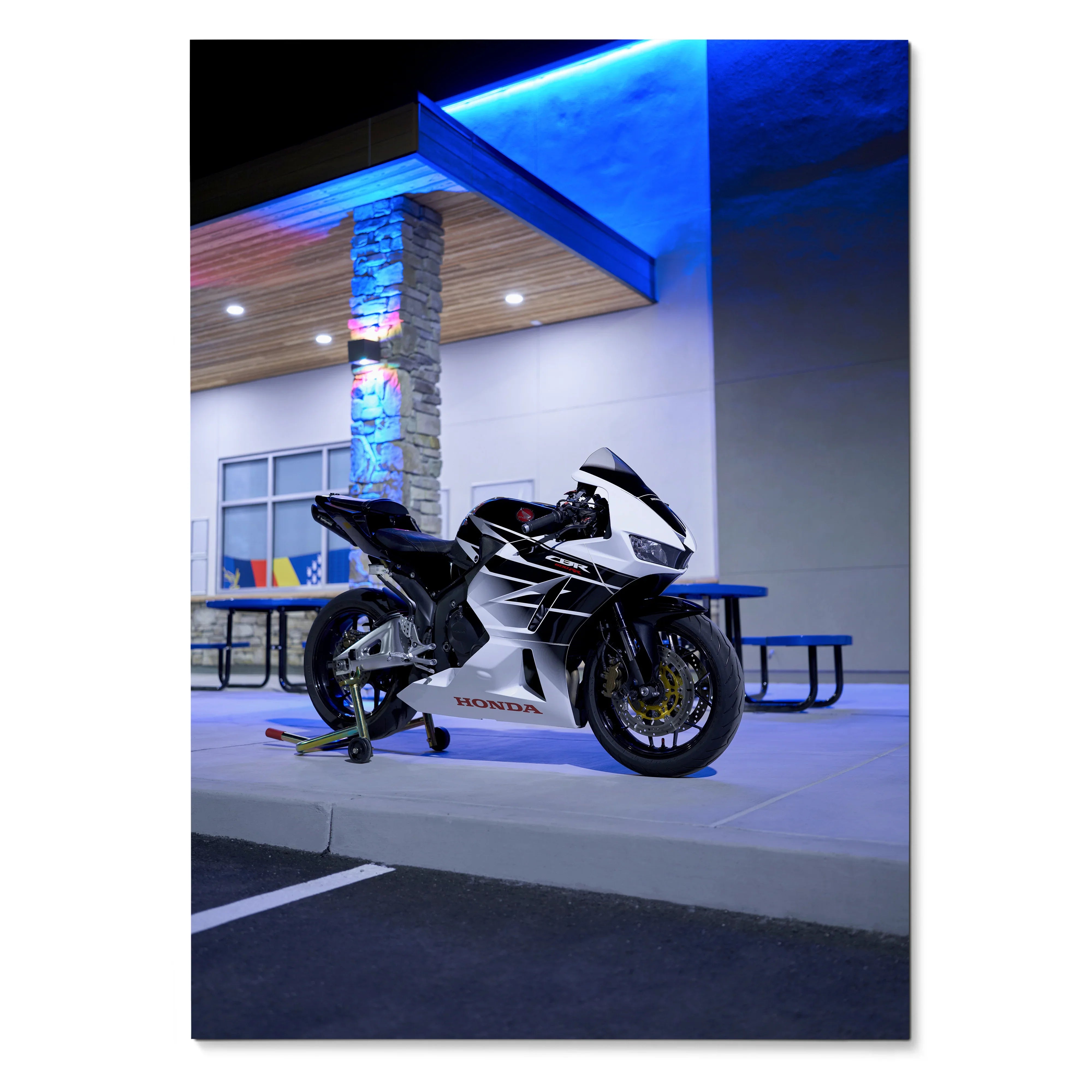 Honda CBR600RR motorcycle poster with black and white sportbike design under blue-lit modern building, wall art.