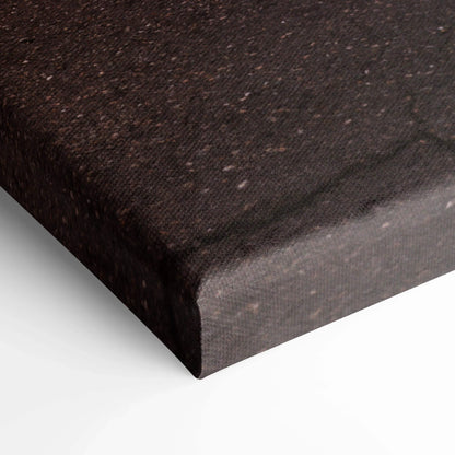 Close-up of textured black canvas corner with wrapped edge, showcasing museum-quality wall art material.