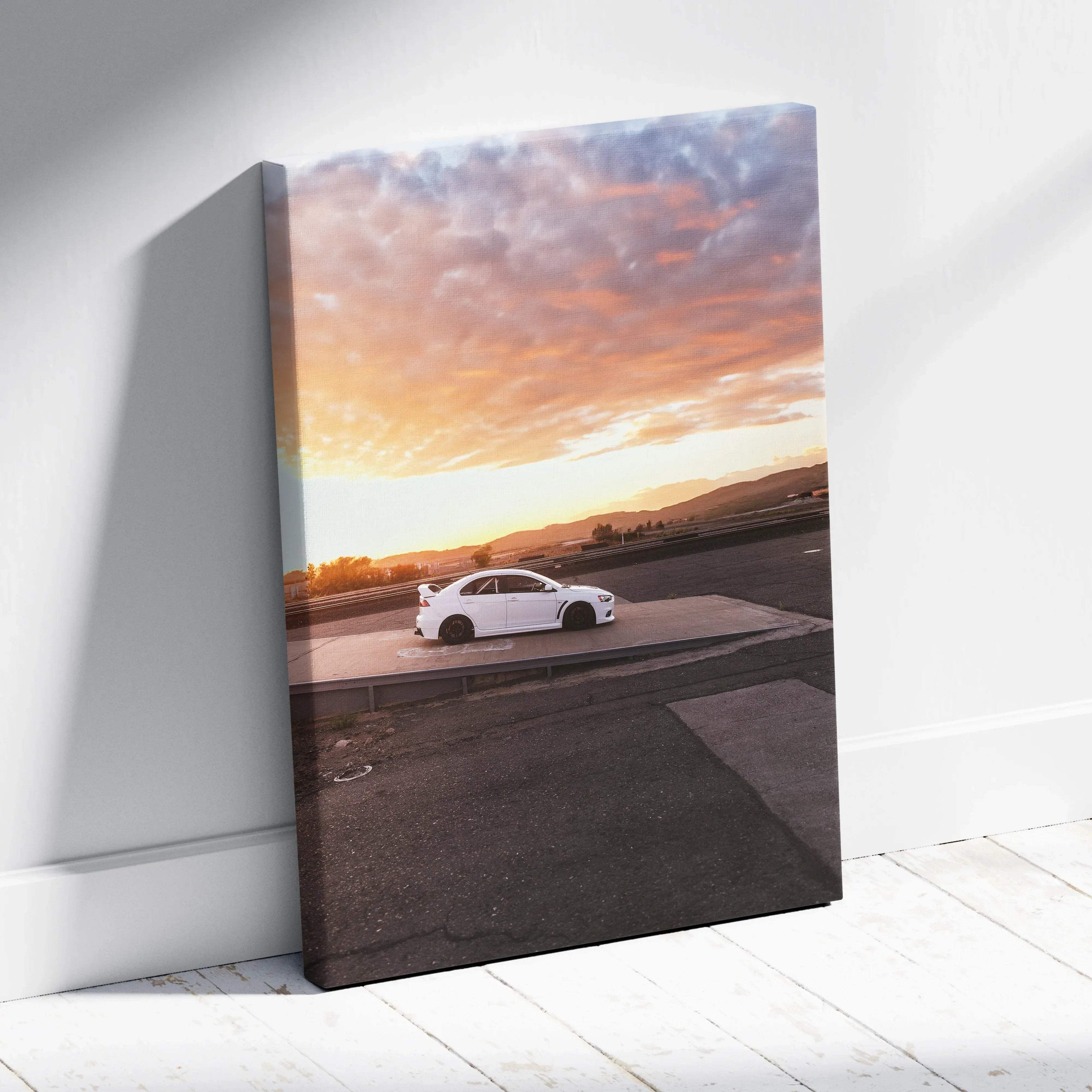 Vertical canvas wall art featuring white Mitsubishi Evo 10 parked at sunset with colorful sky background.