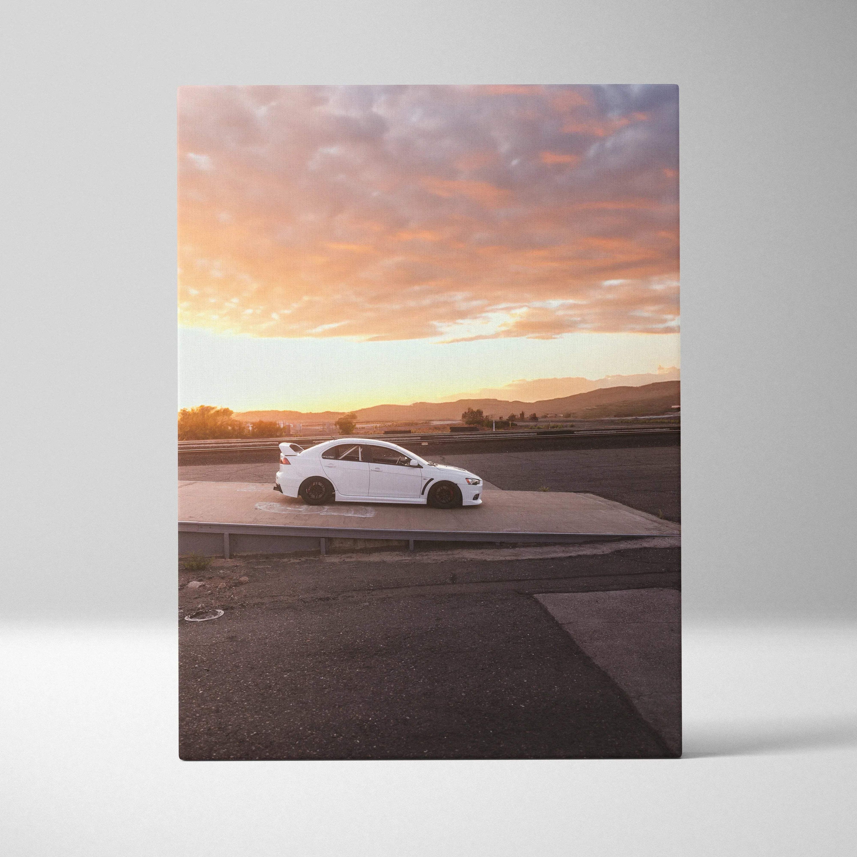 Vertical canvas wall art featuring a white Mitsubishi Evo 10 at sunset with vibrant sky colors.