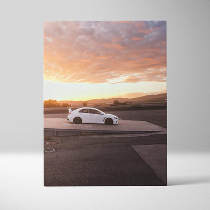 Vertical canvas wall art featuring a white Mitsubishi Evo 10 at sunset with vibrant sky colors.