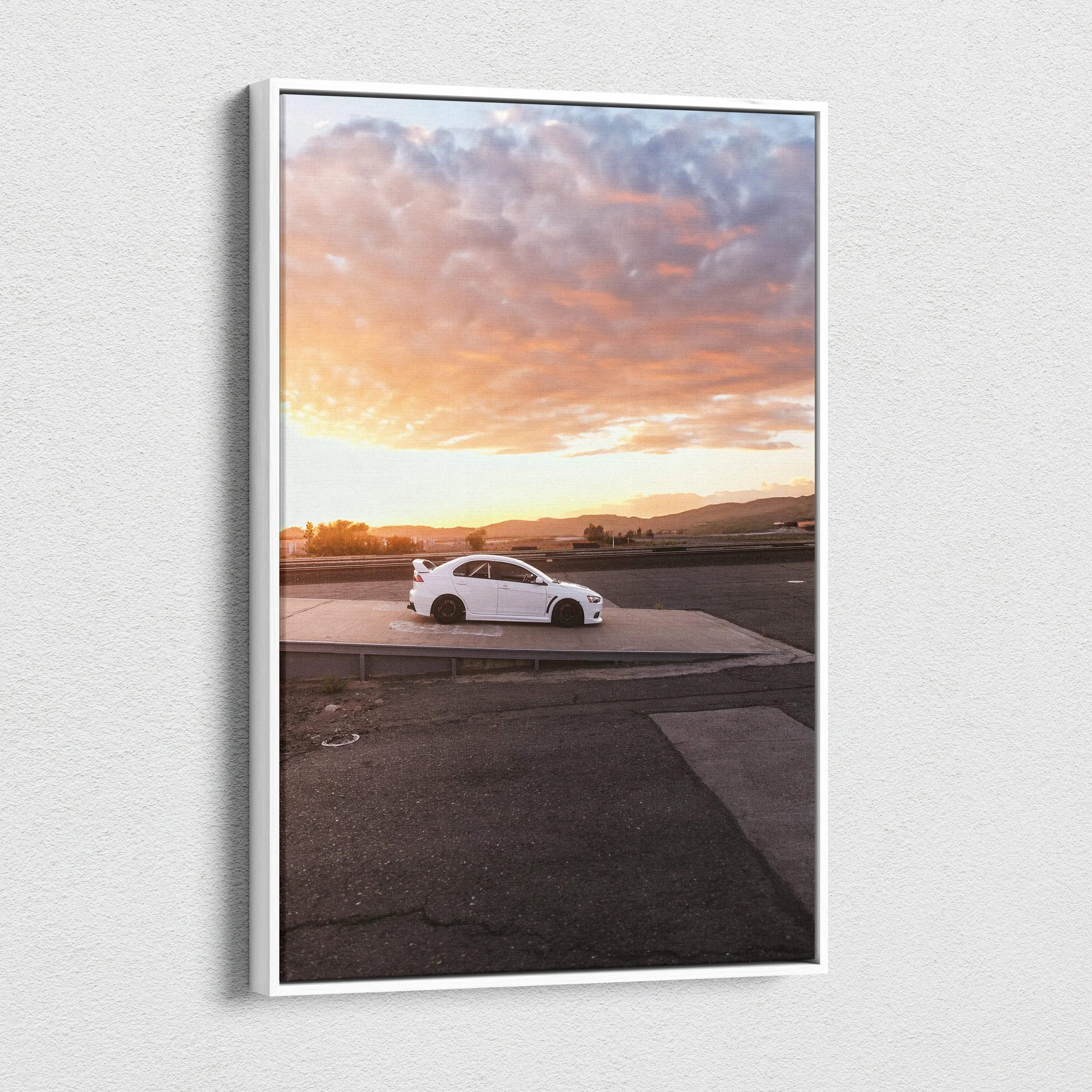 Vertical canvas wall art featuring a white Mitsubishi Evo 10 car at sunset with dramatic clouds.