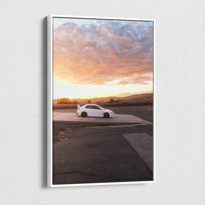 Vertical canvas wall art featuring a white Mitsubishi Evo 10 car at sunset with dramatic clouds.