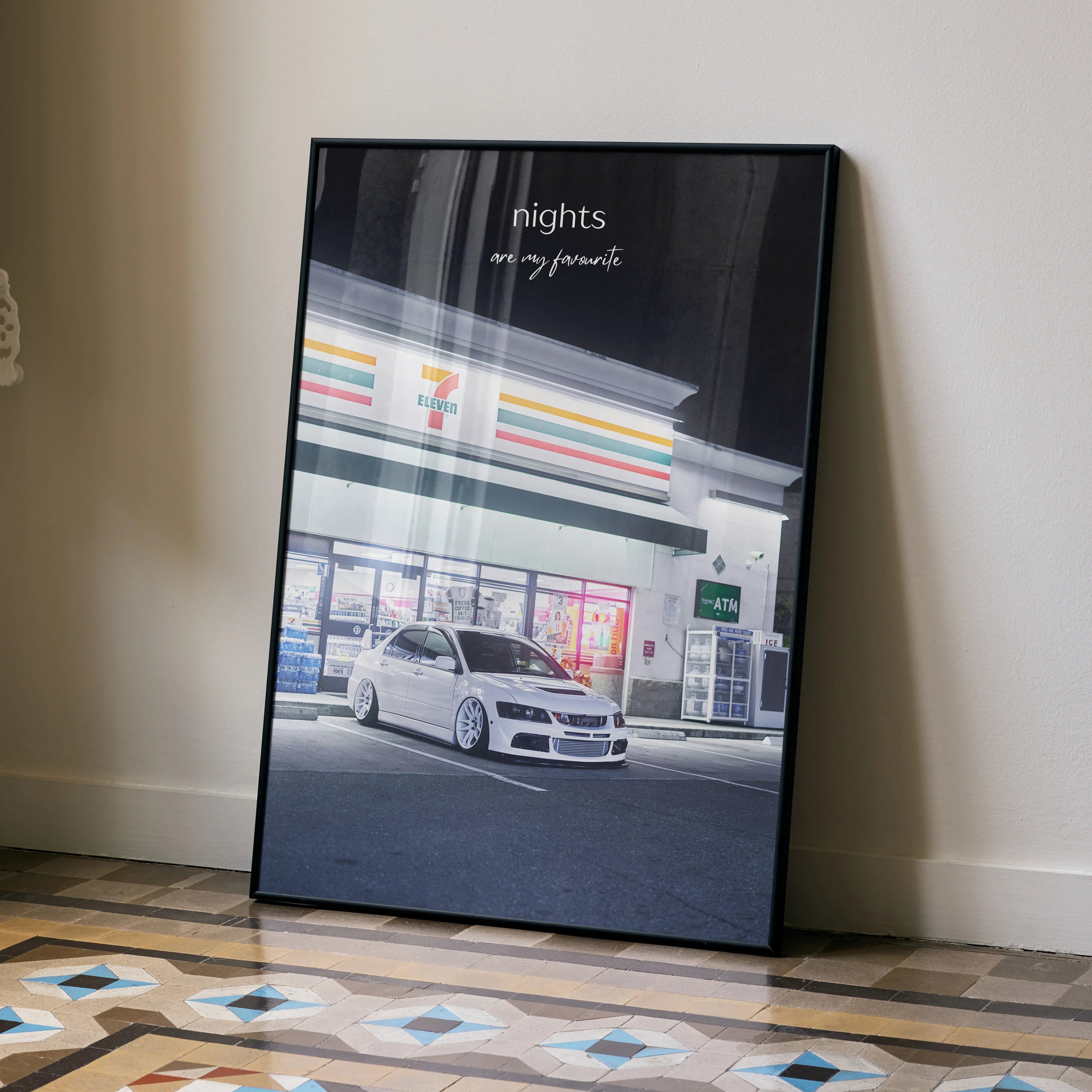 Motivational poster wall art featuring a white Mitsubishi Evo 8 parked under gas station lights at night.