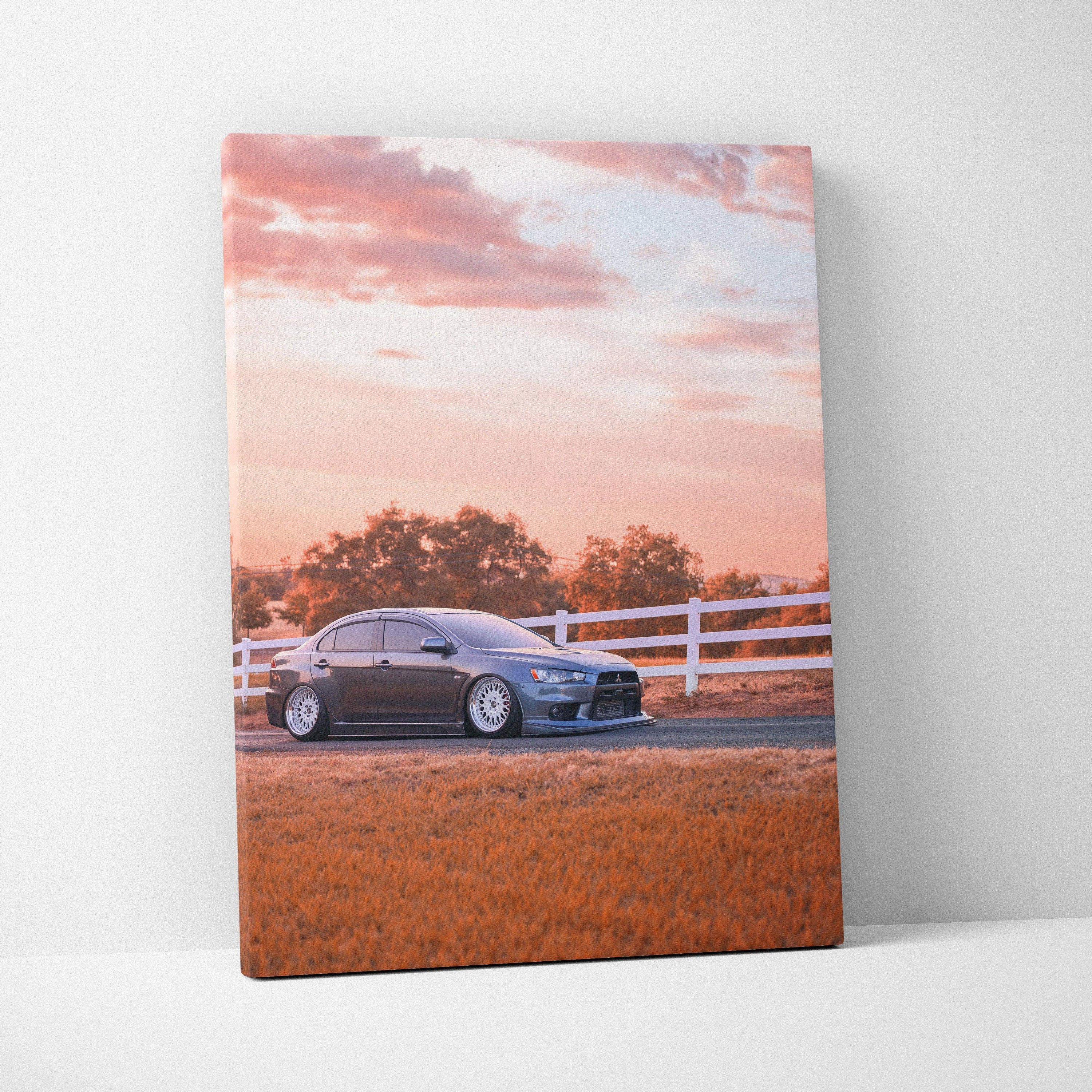 Mitsubishi Evo 10 car on canvas wall art with sunset sky and white fence background.