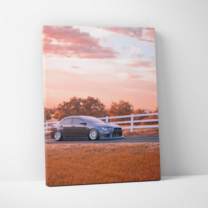 Mitsubishi Evo 10 car on canvas wall art with sunset sky and white fence background.
