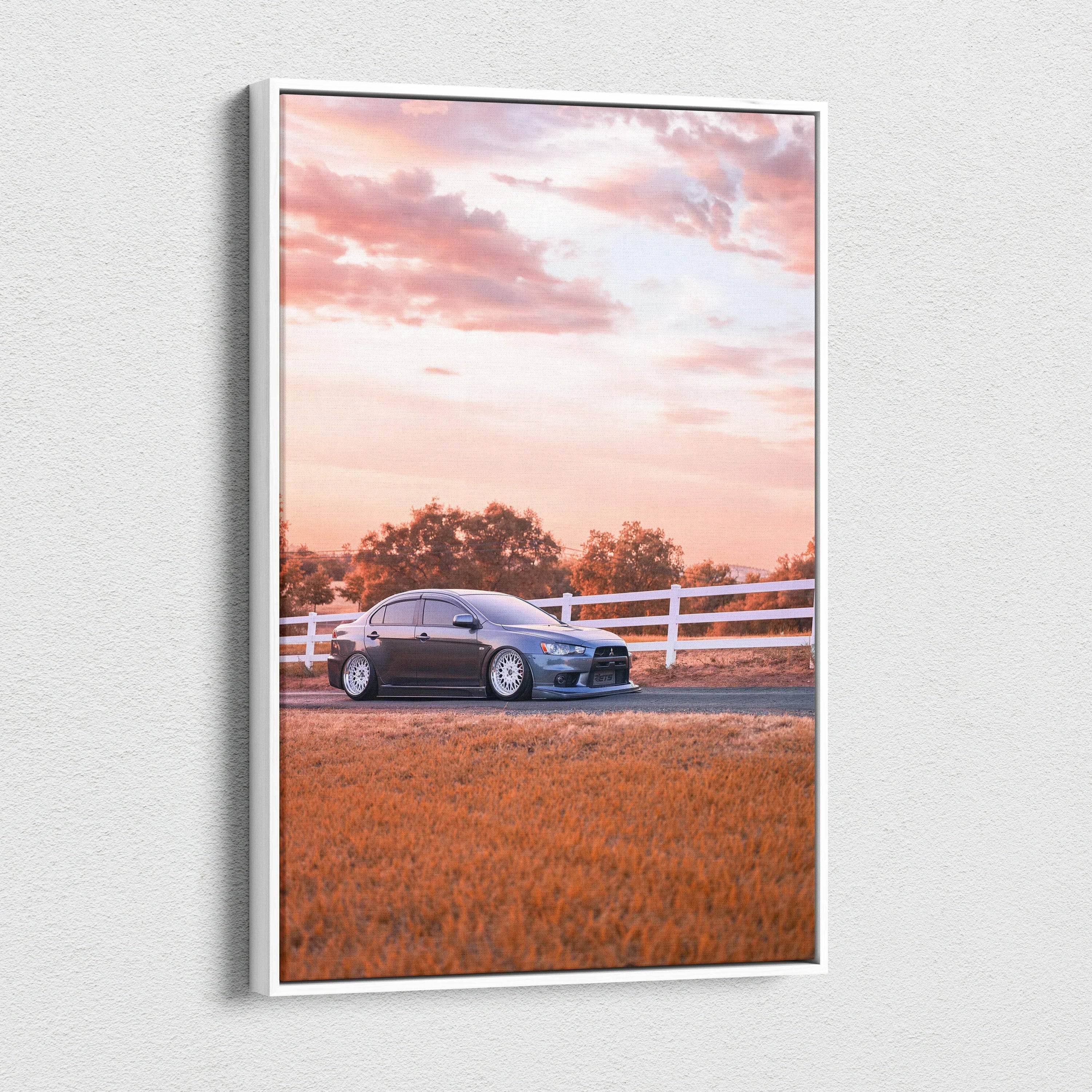 Vertical canvas wall art featuring a Mitsubishi Evo 10 car against a sunset sky with fence and grass.