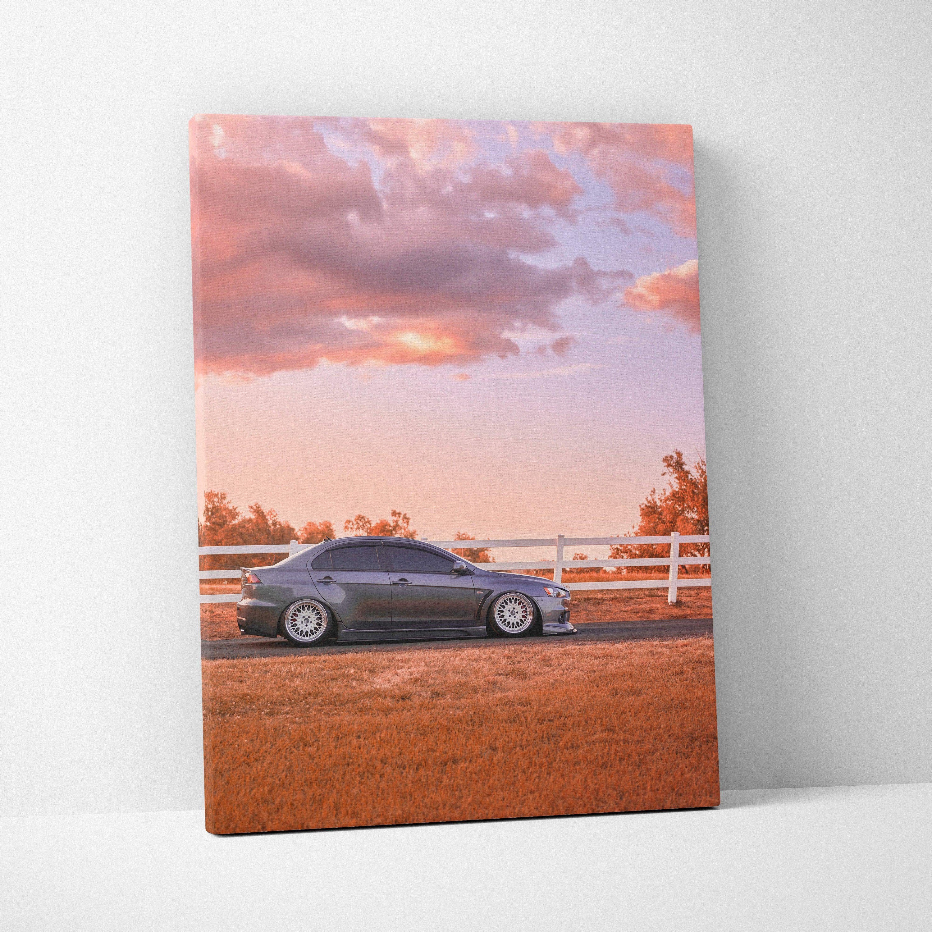 Mitsubishi Evo 10 parked in front of white fence at sunset on vertical canvas wall art.