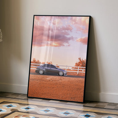 Mitsubishi Evo 10 poster wall art with sunset sky and rural fence background in black frame.