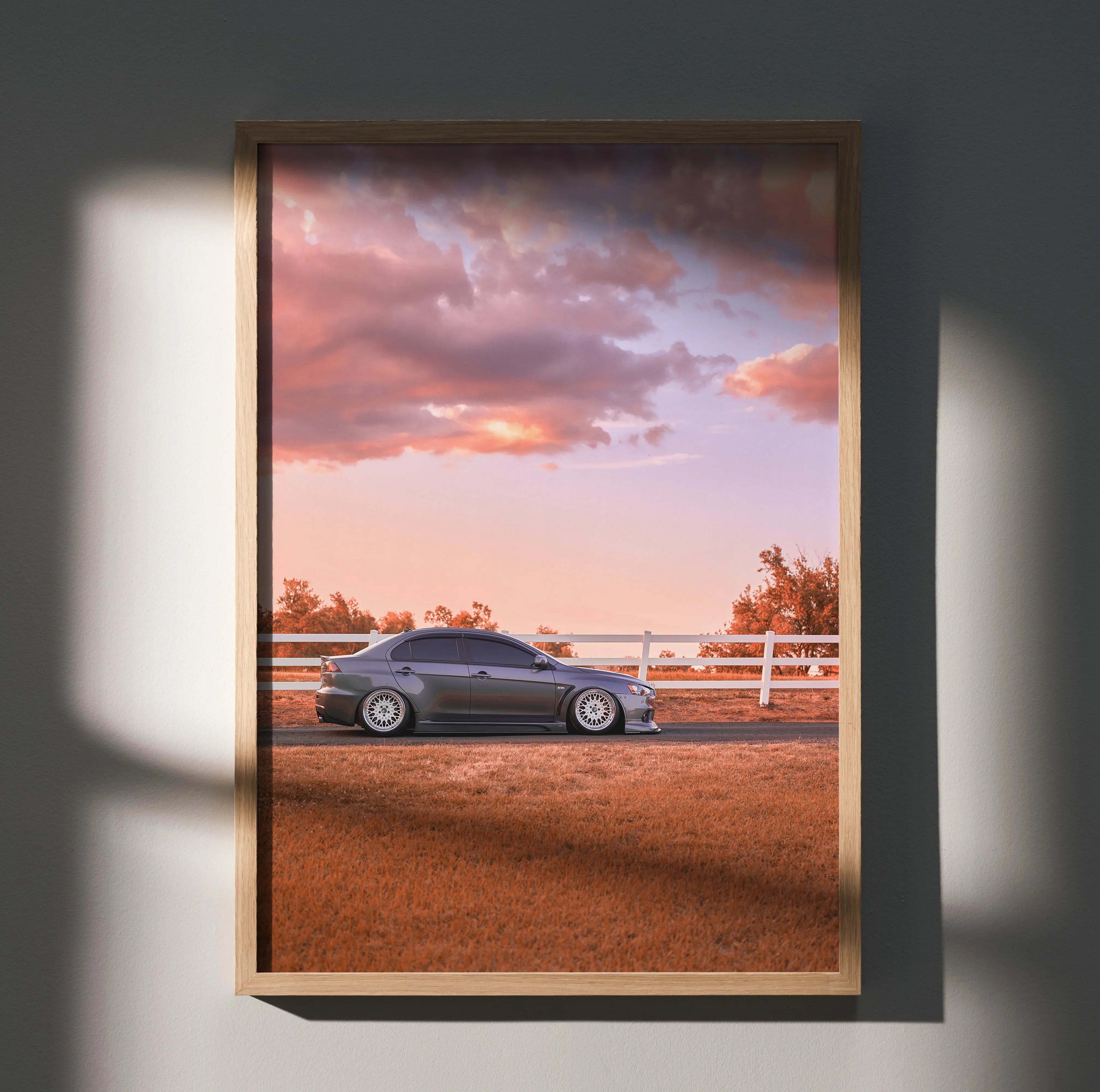 Mitsubishi Evo 10 parked on dirt road at sunset poster wall art in wooden frame.