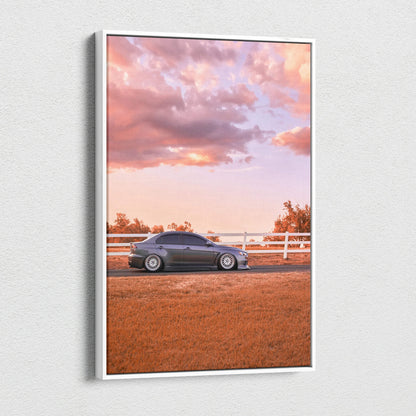 Mitsubishi Evo 10 parked on a dirt road at sunset with vibrant orange sky canvas wall art.