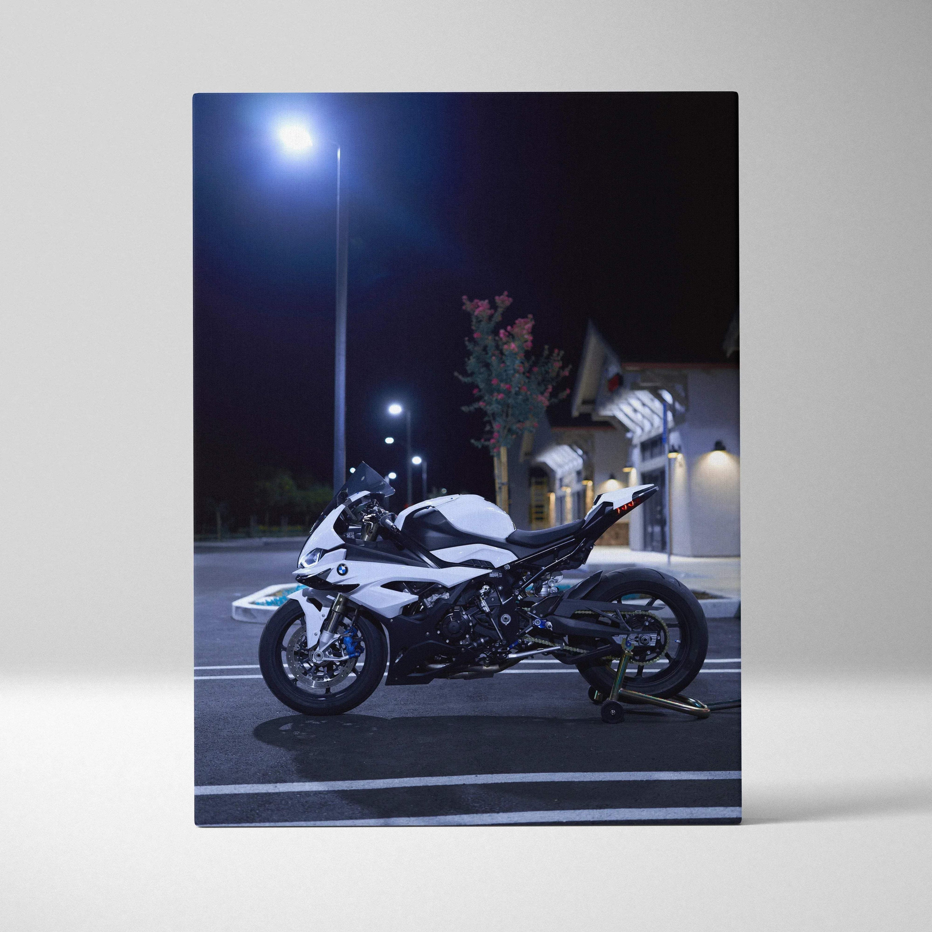 BMW S1000RR motorcycle vertical canvas art with sleek white and black design under streetlight at night.