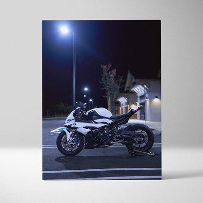BMW S1000RR motorcycle vertical canvas art with sleek white and black design under streetlight at night.