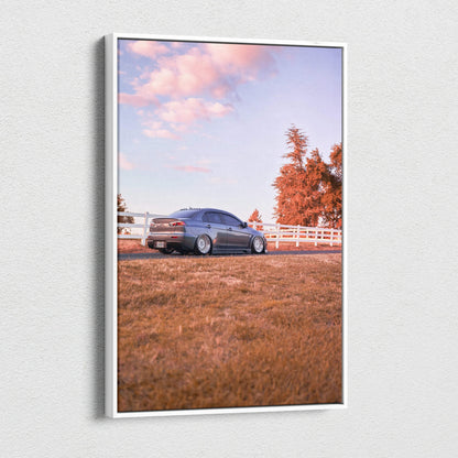 Mitsubishi Evo 10 in blue parked on grass with autumn trees and white fence, vertical canvas art wall decor.