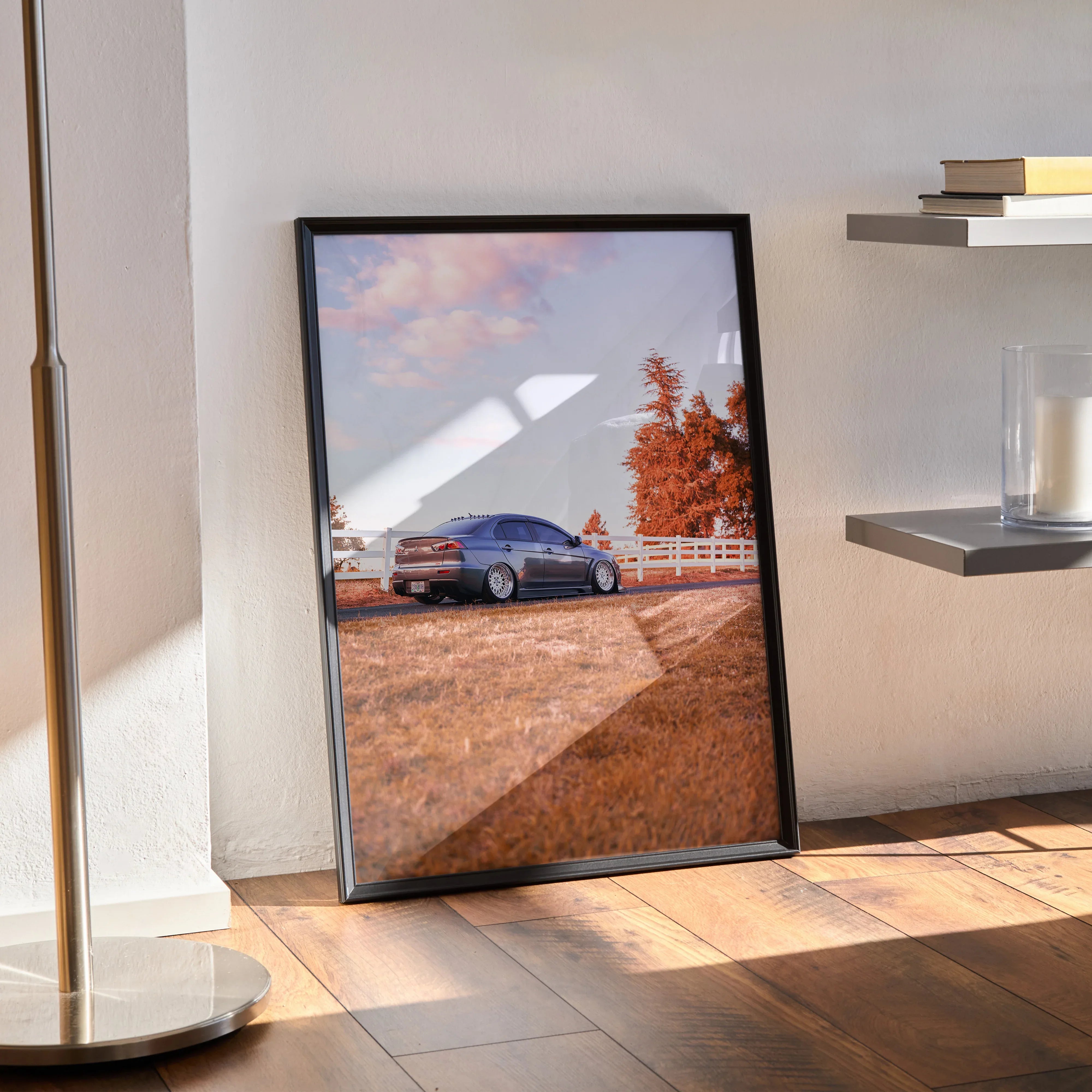 Mitsubishi Evo 10 poster wall art featuring a blue car on a dirt road with autumn trees and a fence in the background.