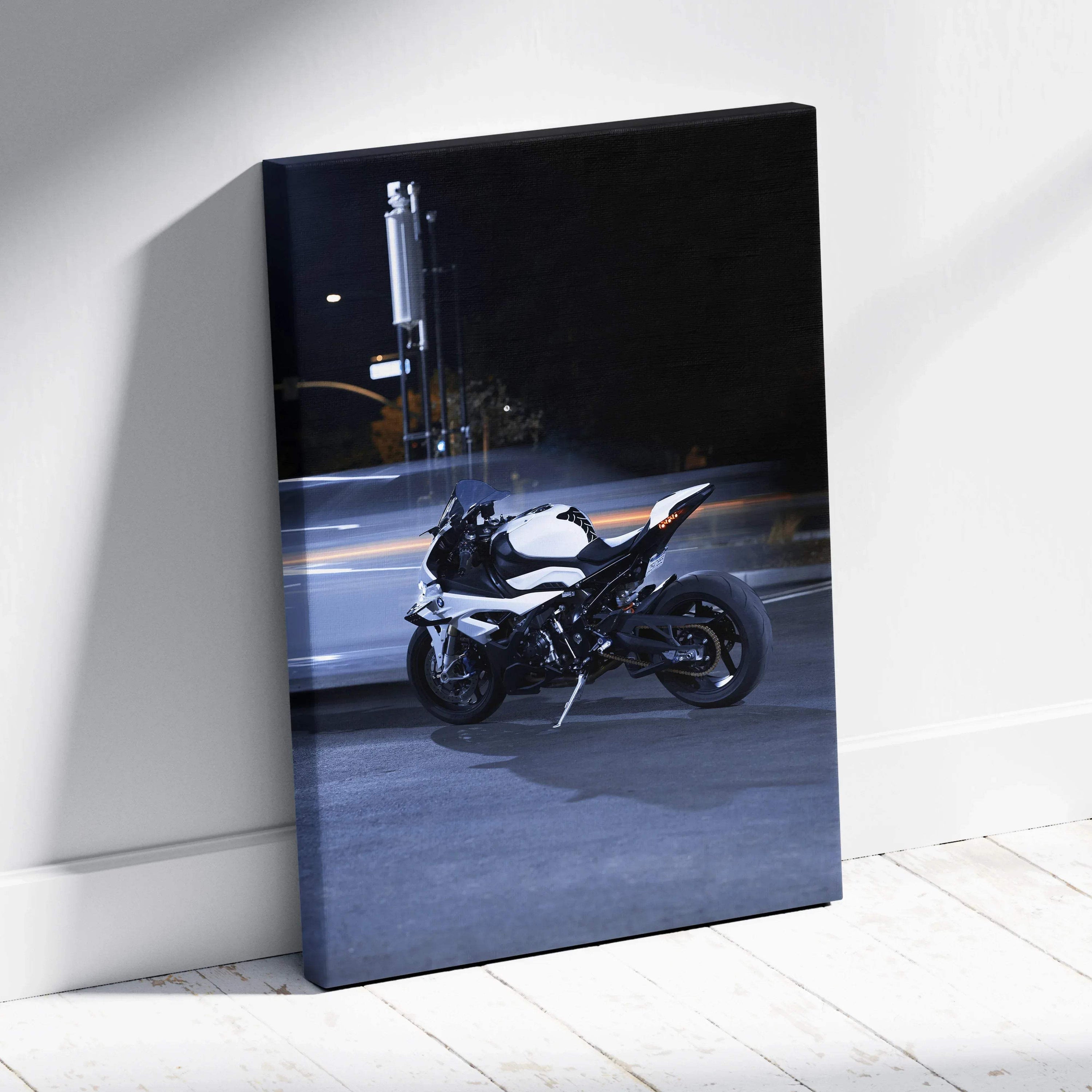Vertical canvas wall art featuring a sleek black and white BMW S1000RR motorcycle at night.