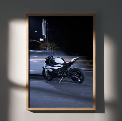 BMW S1000RR motorcycle poster wall art with sleek white and black bike against dark city background.