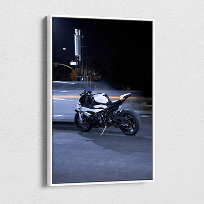 Vertical canvas art of a BMW S1000RR motorcycle parked on a dimly lit urban street at night.