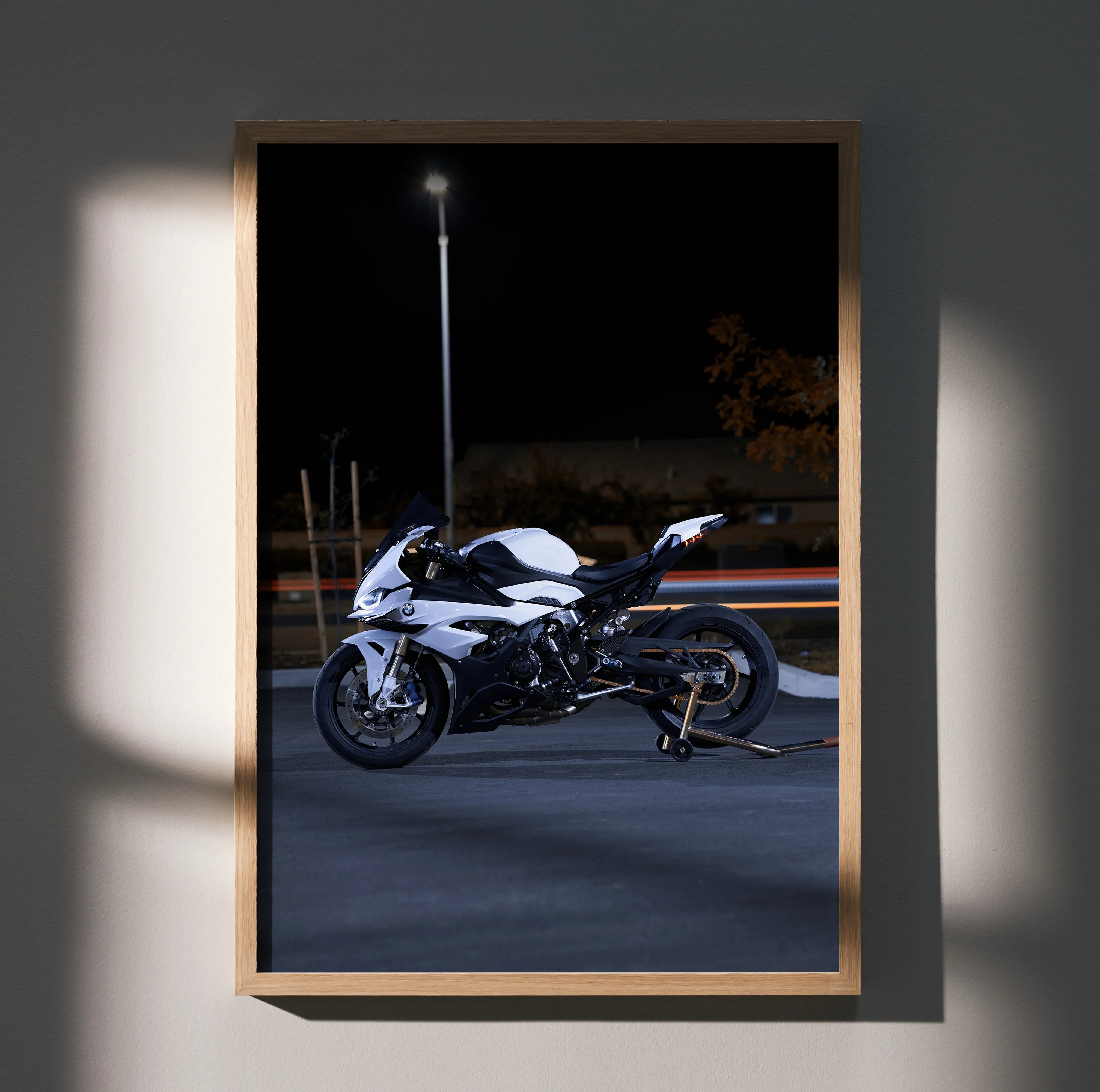 BMW S1000RR motorcycle poster with black and white bike against dark night background wall art.