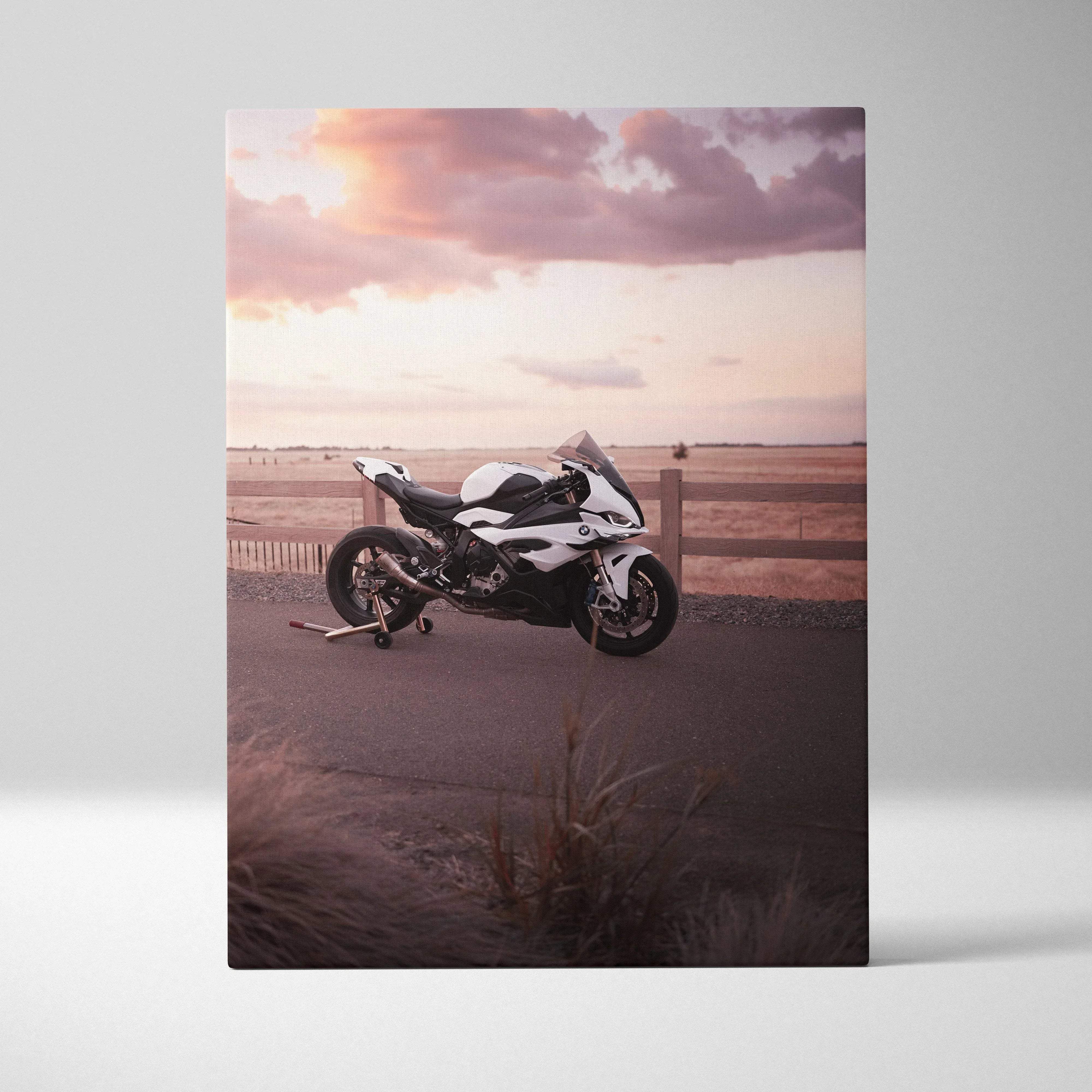 Canvas wall art featuring a white and black bmw s1000rr sport motorcycle parked on a paved road at sunset