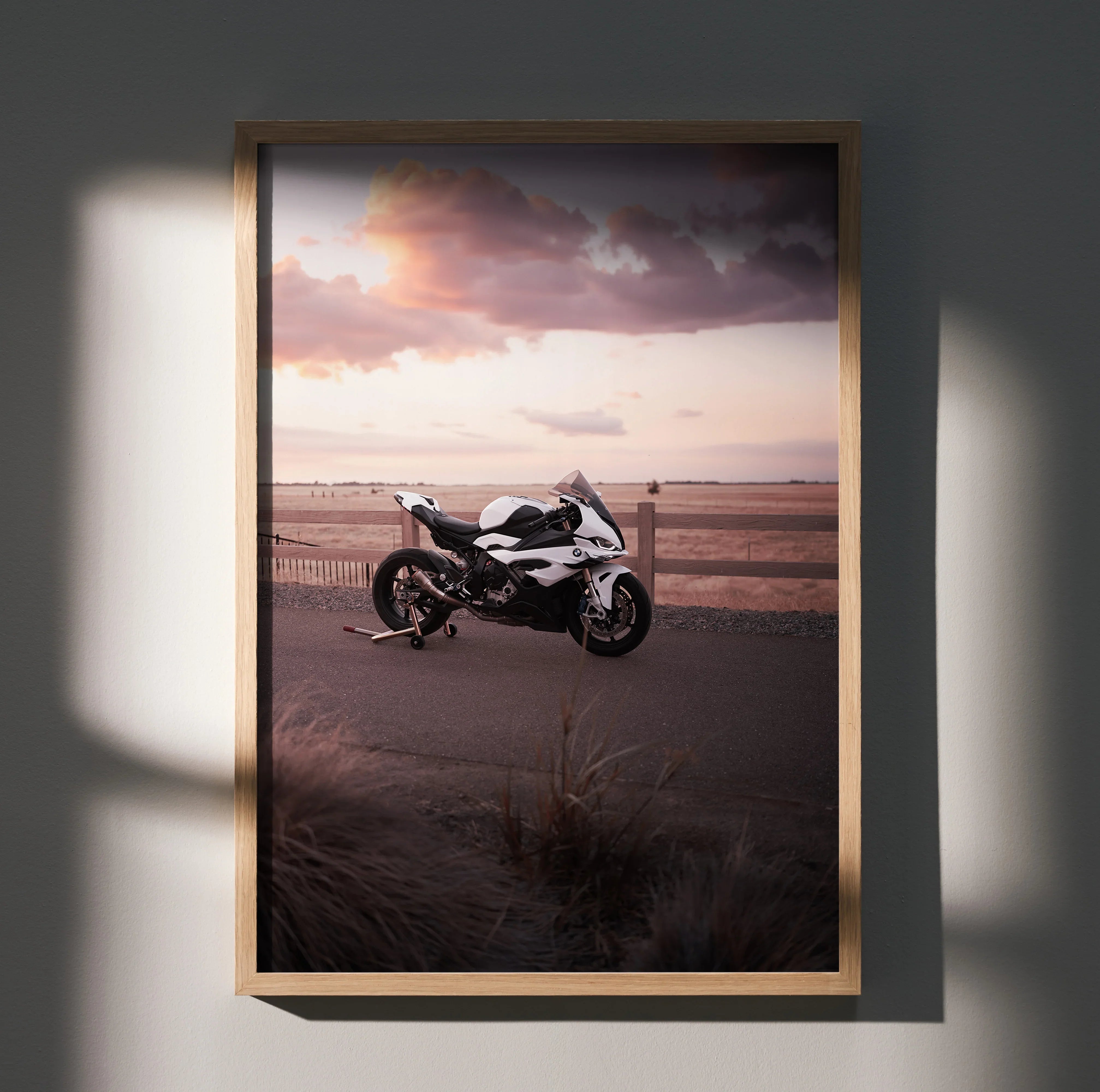 BMW S1000RR motorcycle parked on open road at sunset poster wall art in wooden frame.