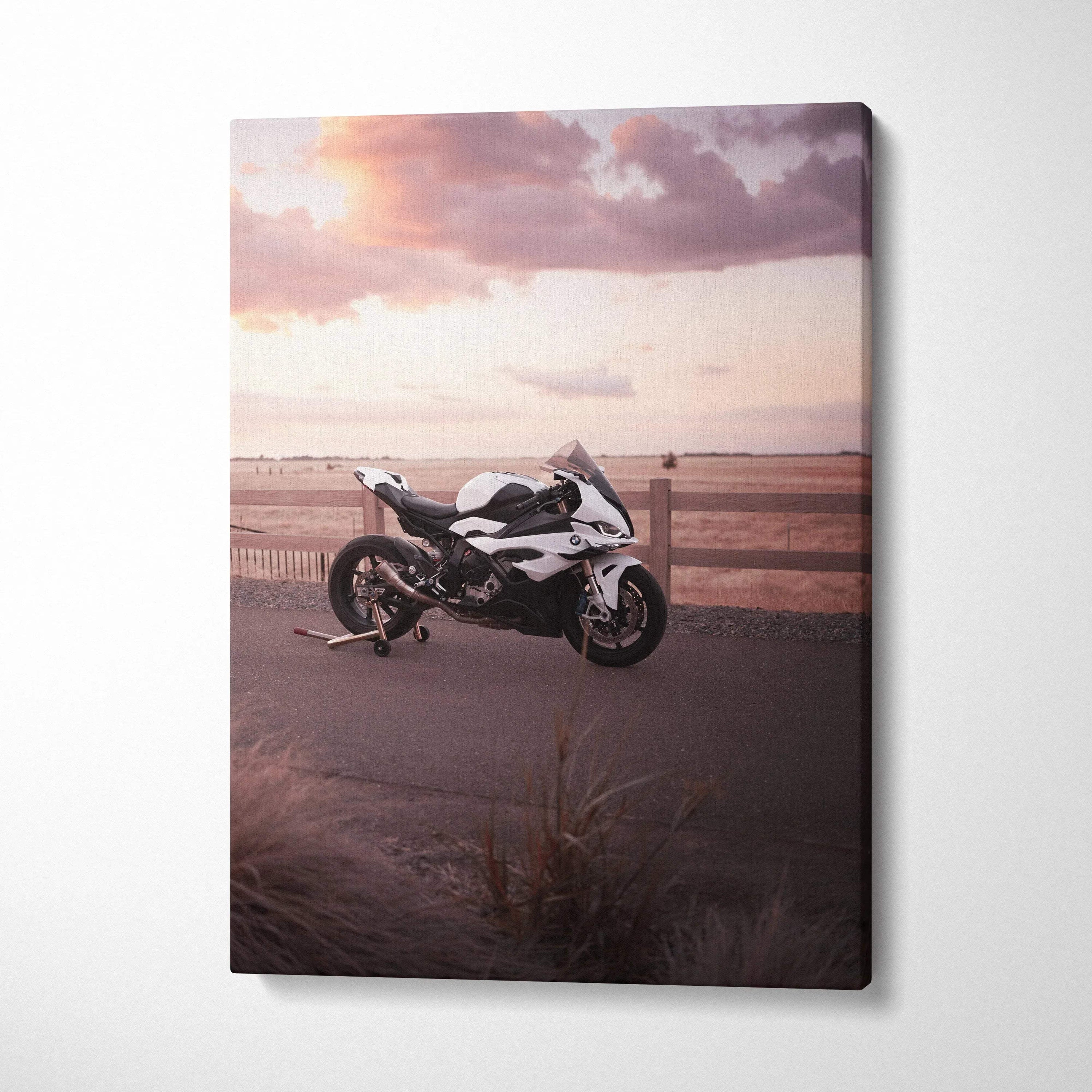 BMW S1000RR motorcycle against a sunset sky on vertical canvas wall art.