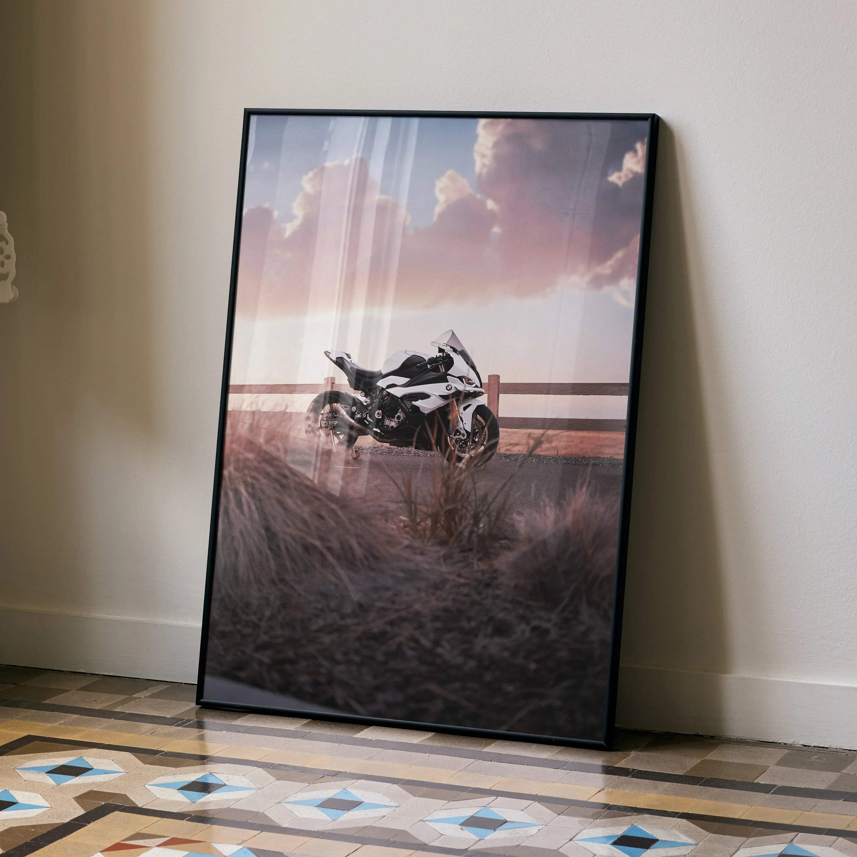 BMW S1000RR motorcycle poster with sunset sky, framed wall art leaning on floor.