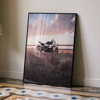 BMW S1000RR motorcycle poster with sunset sky, framed wall art leaning on floor.