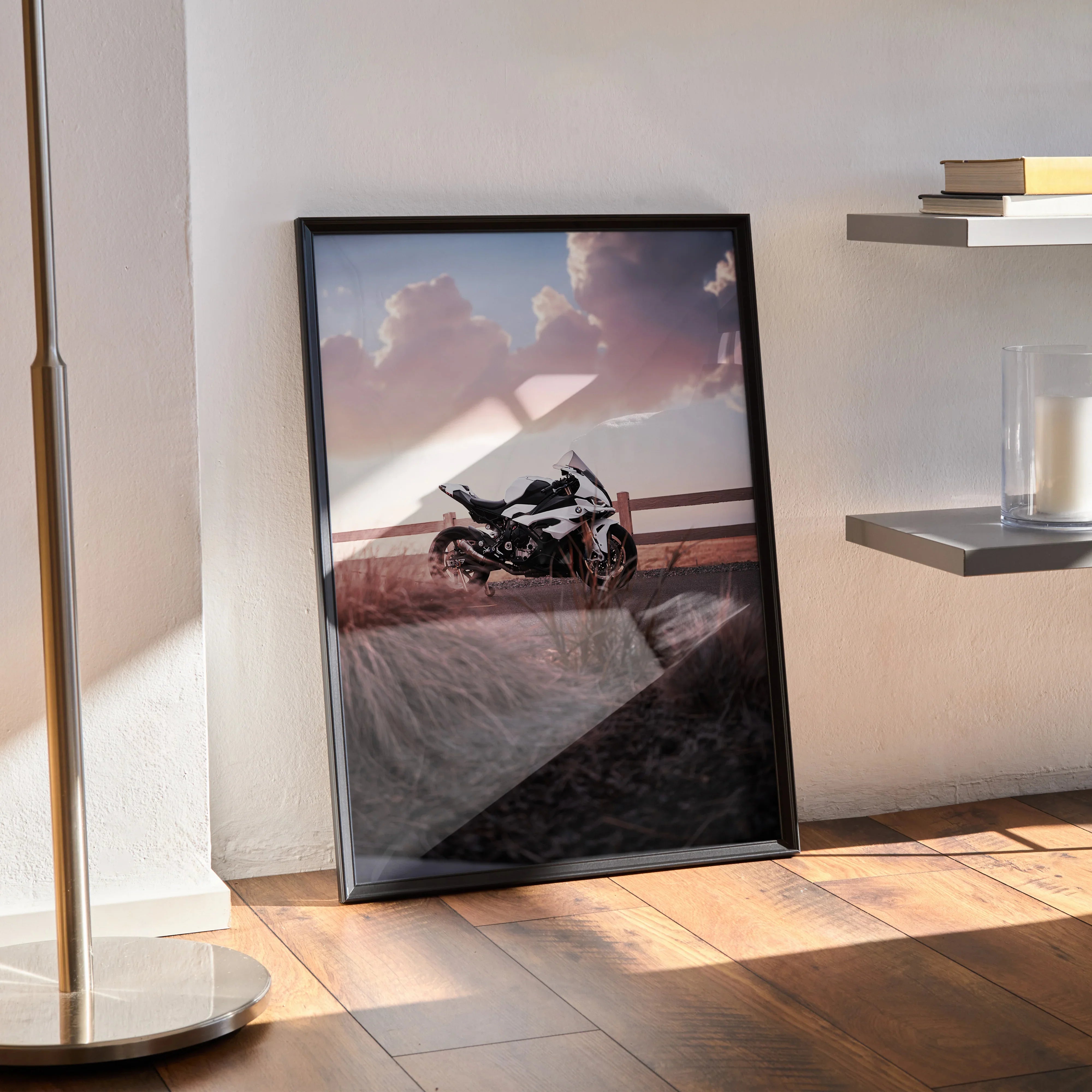 BMW S1000RR motorcycle poster with sunset background, framed wall art leaning on floor.