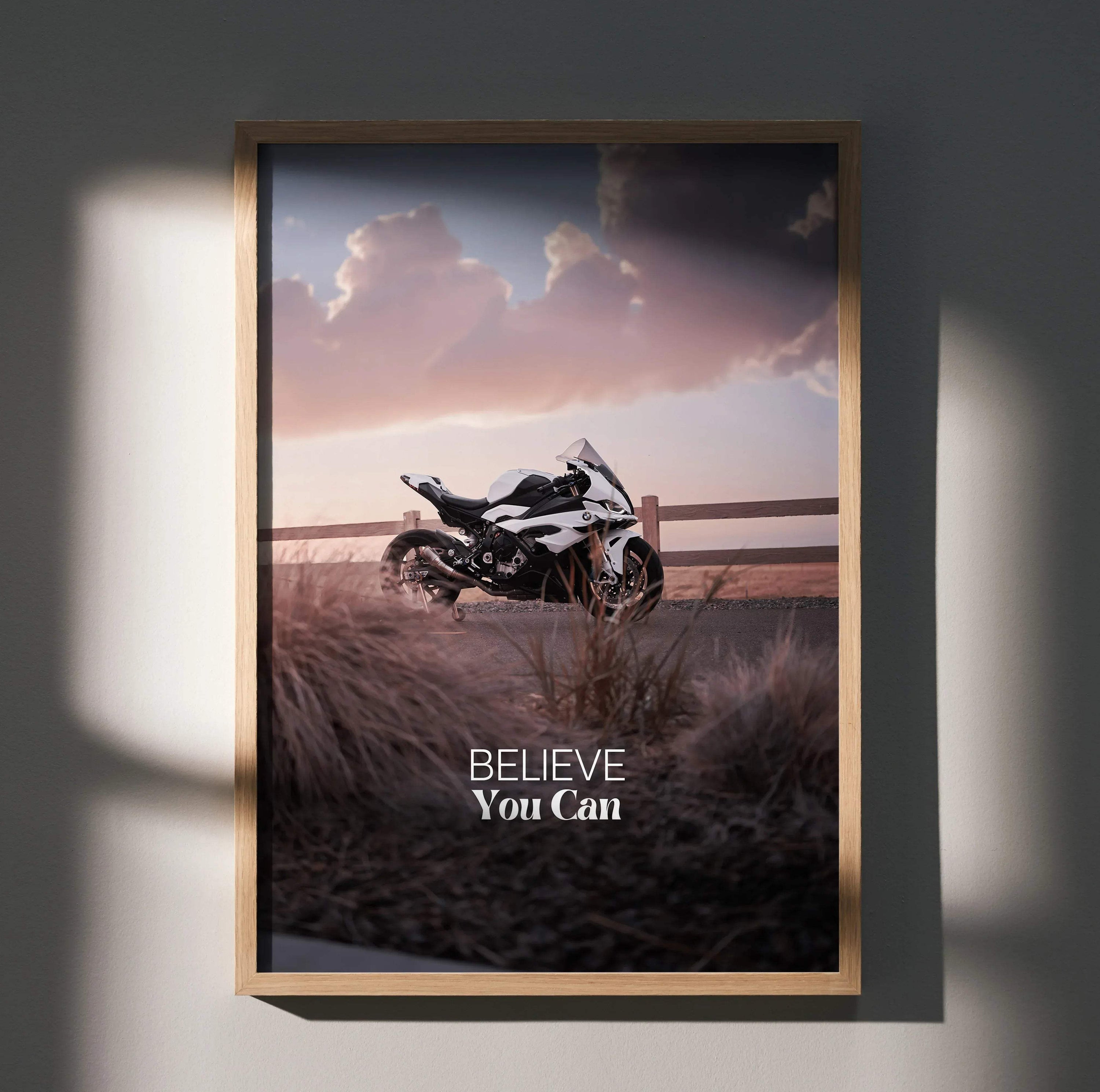 Motivational poster wall art featuring BMW S1000RR motorcycle with "Believe You Can" text and sunset background.