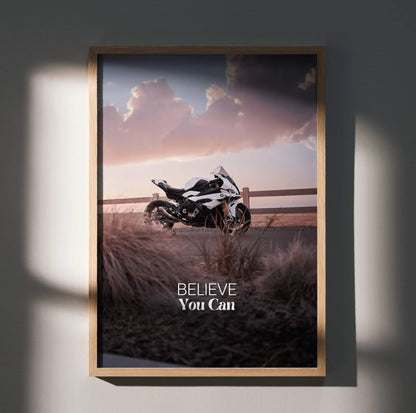 Motivational poster wall art featuring BMW S1000RR motorcycle with "Believe You Can" text and sunset background.