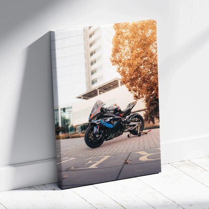 BMW M1000RR motorcycle on canvas wall art with urban background and autumn tree.