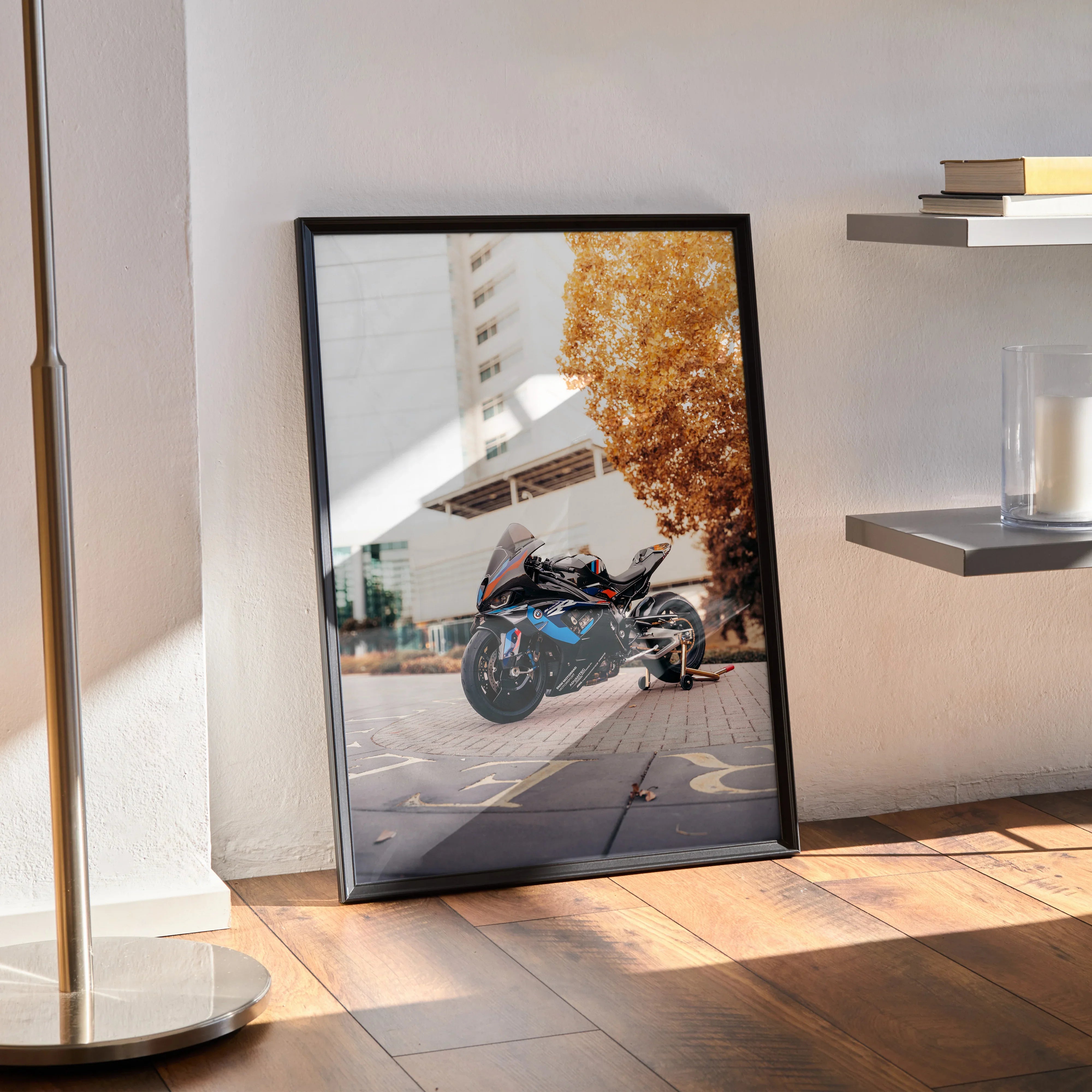 BMW M1000RR motorcycle poster leaning against wall with autumn tree in background, modern wall art.