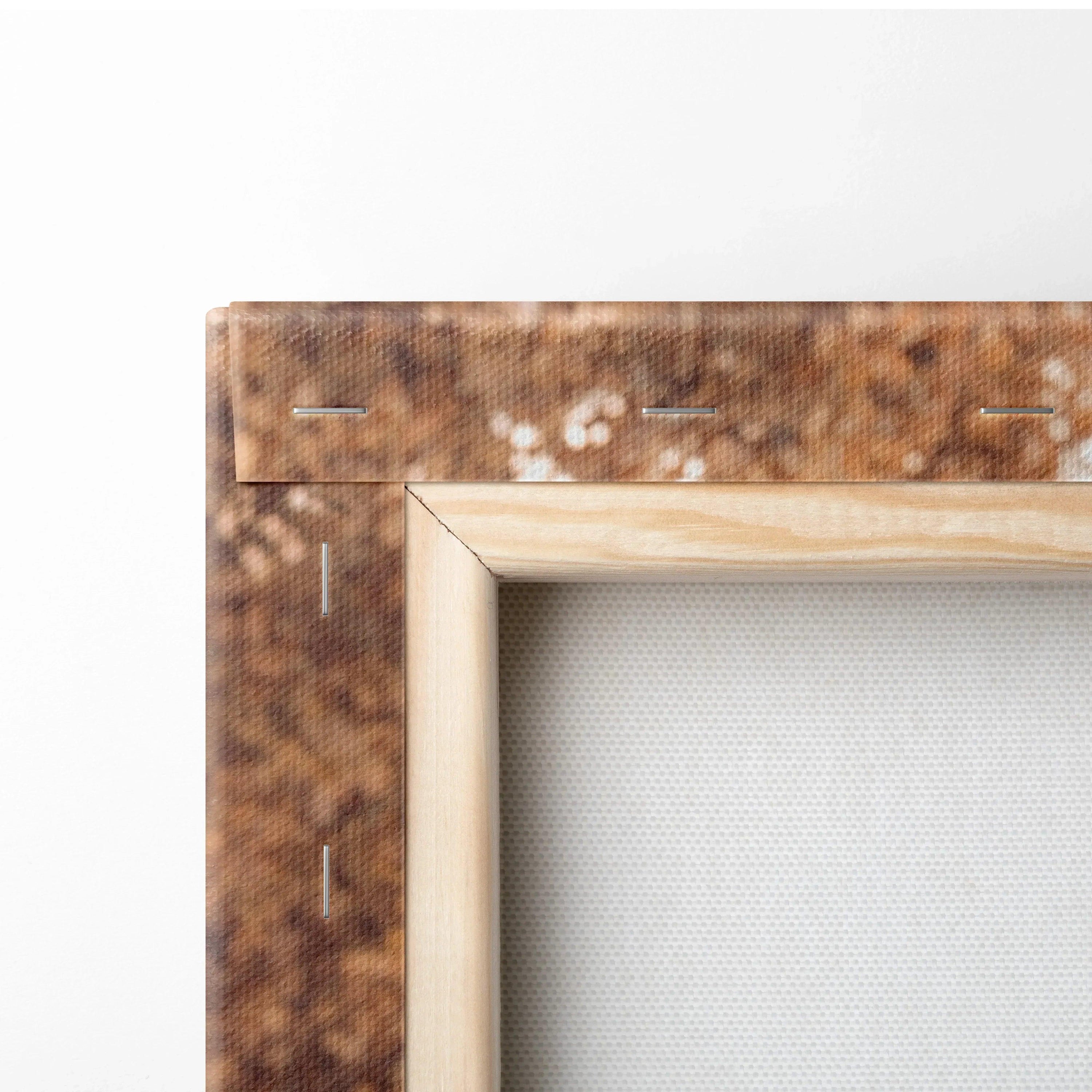 Close-up of wooden stretcher bars and stapled edges on blank canvas wall art.